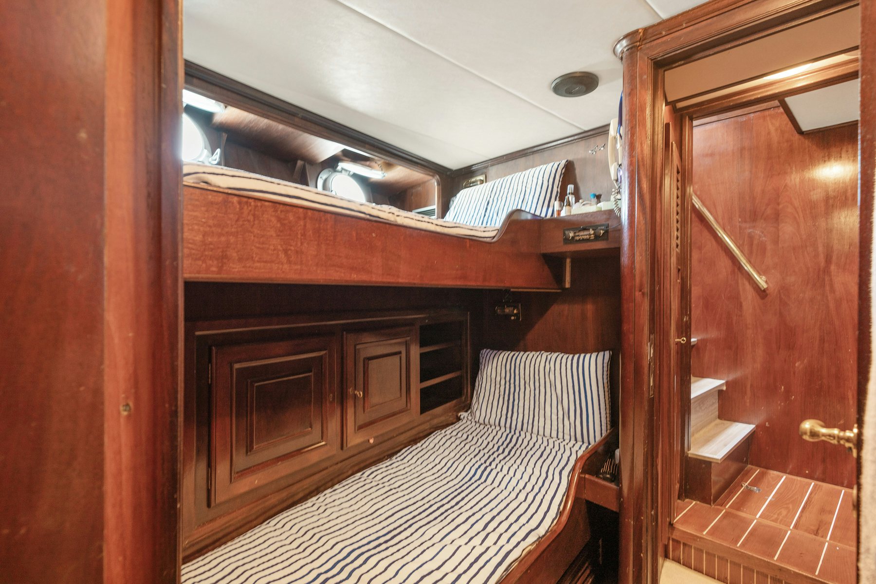 a room with a bed and a wood door aboard AMMIRAGLIO Yacht for Sale