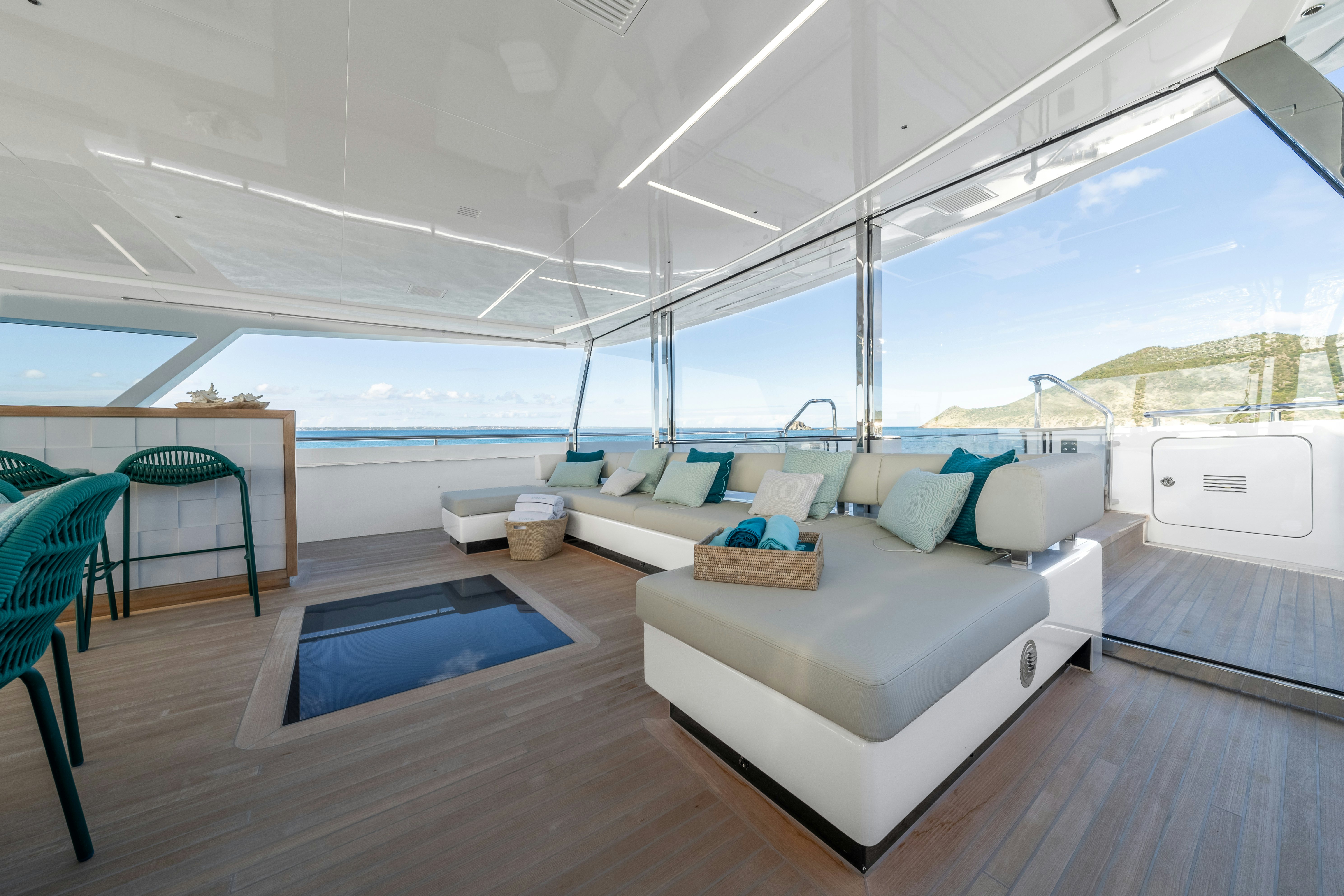 a living room with a large window aboard EMOCEAN Yacht for Sale