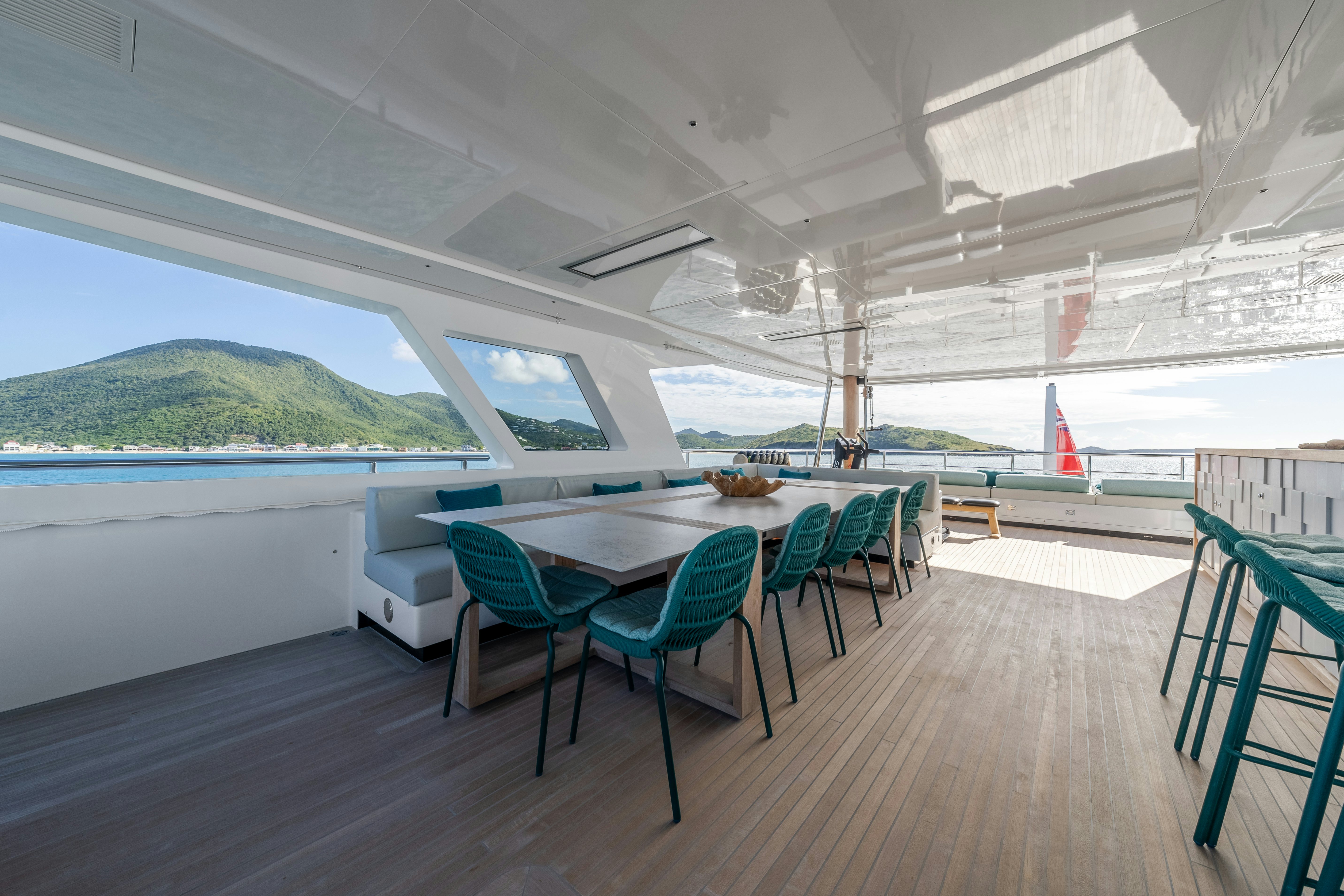 a room with a table and chairs aboard EMOCEAN Yacht for Sale