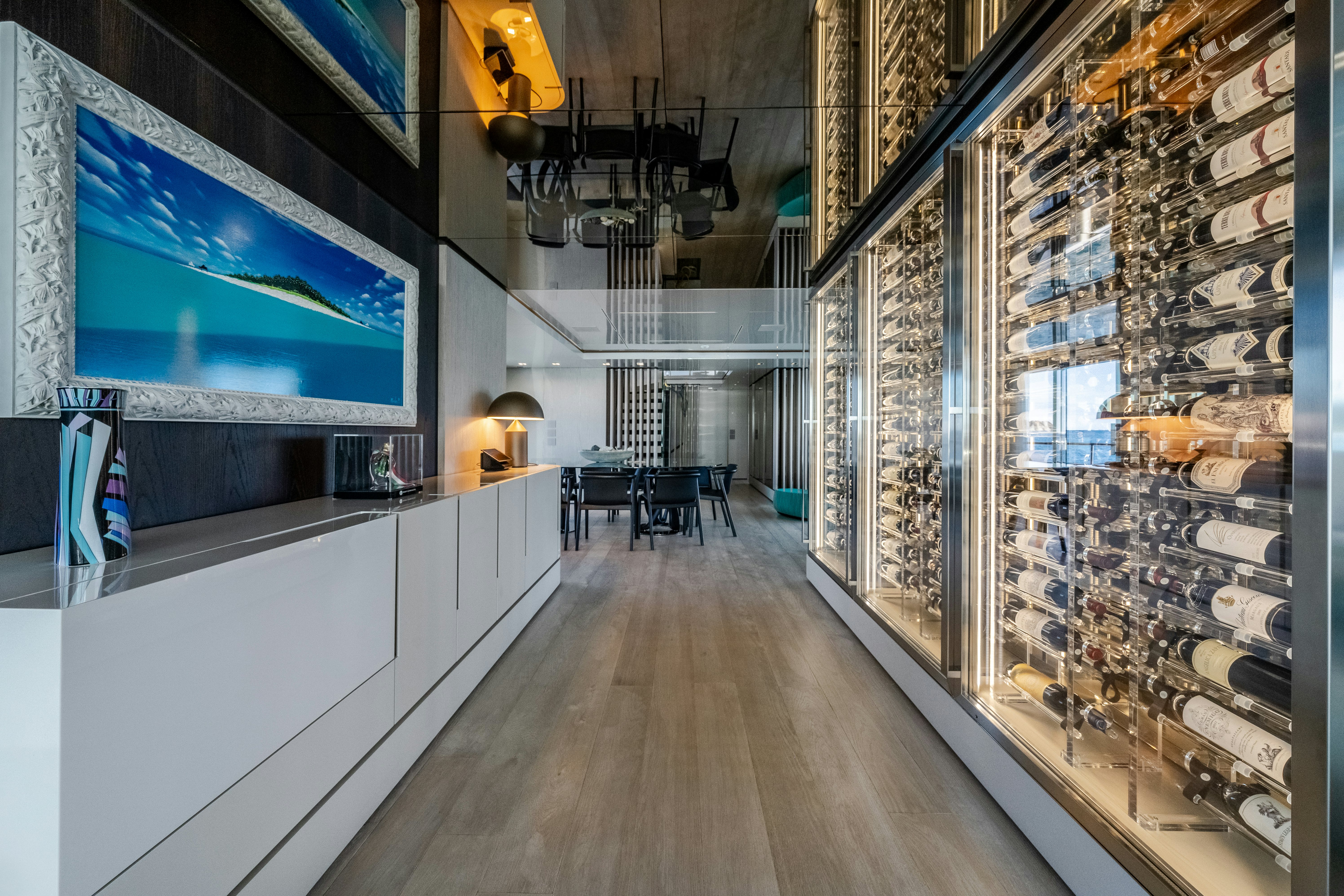 a room with a wood floor and a large wall with art on it aboard EMOCEAN Yacht for Sale