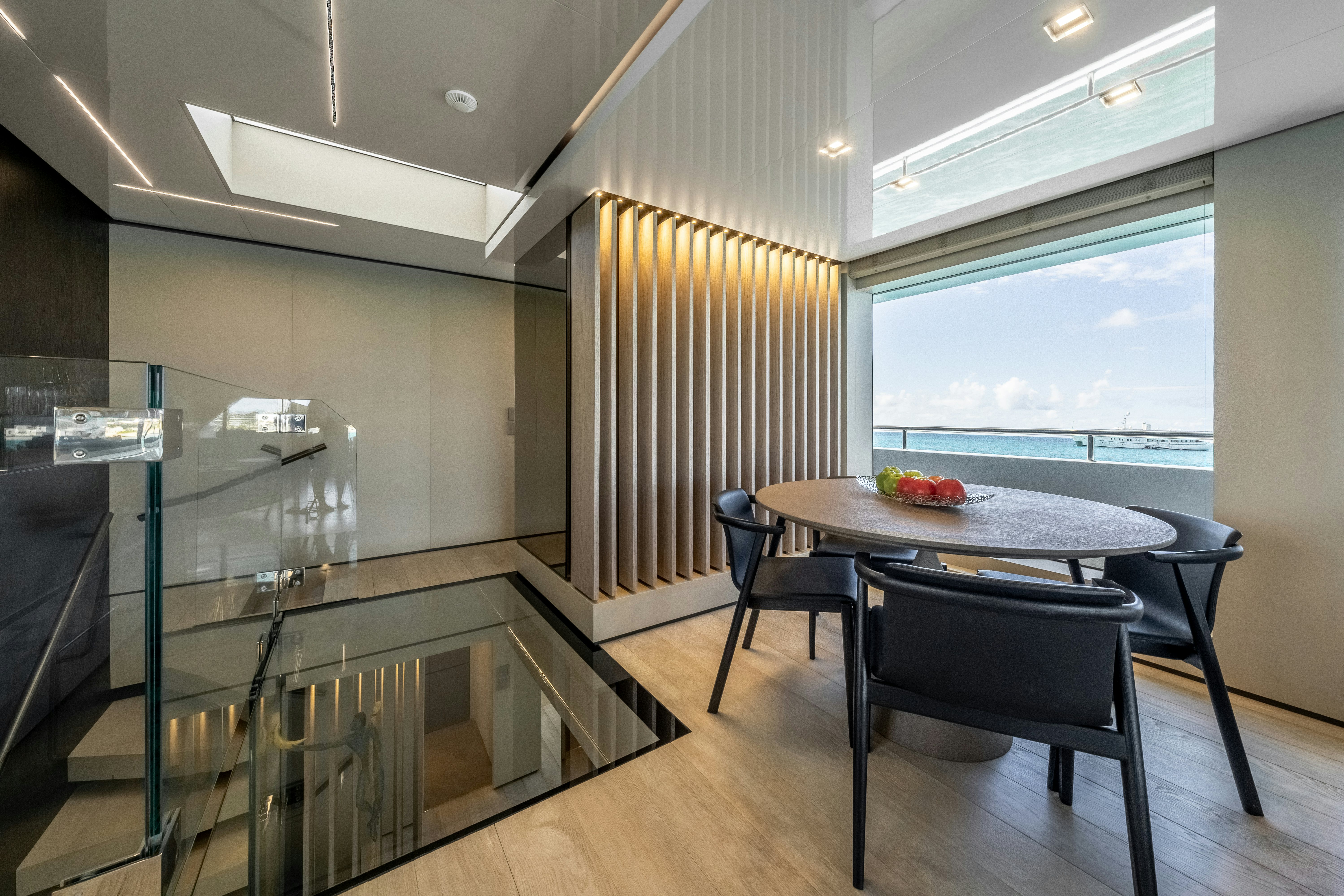 a room with a table and chairs aboard EMOCEAN Yacht for Sale