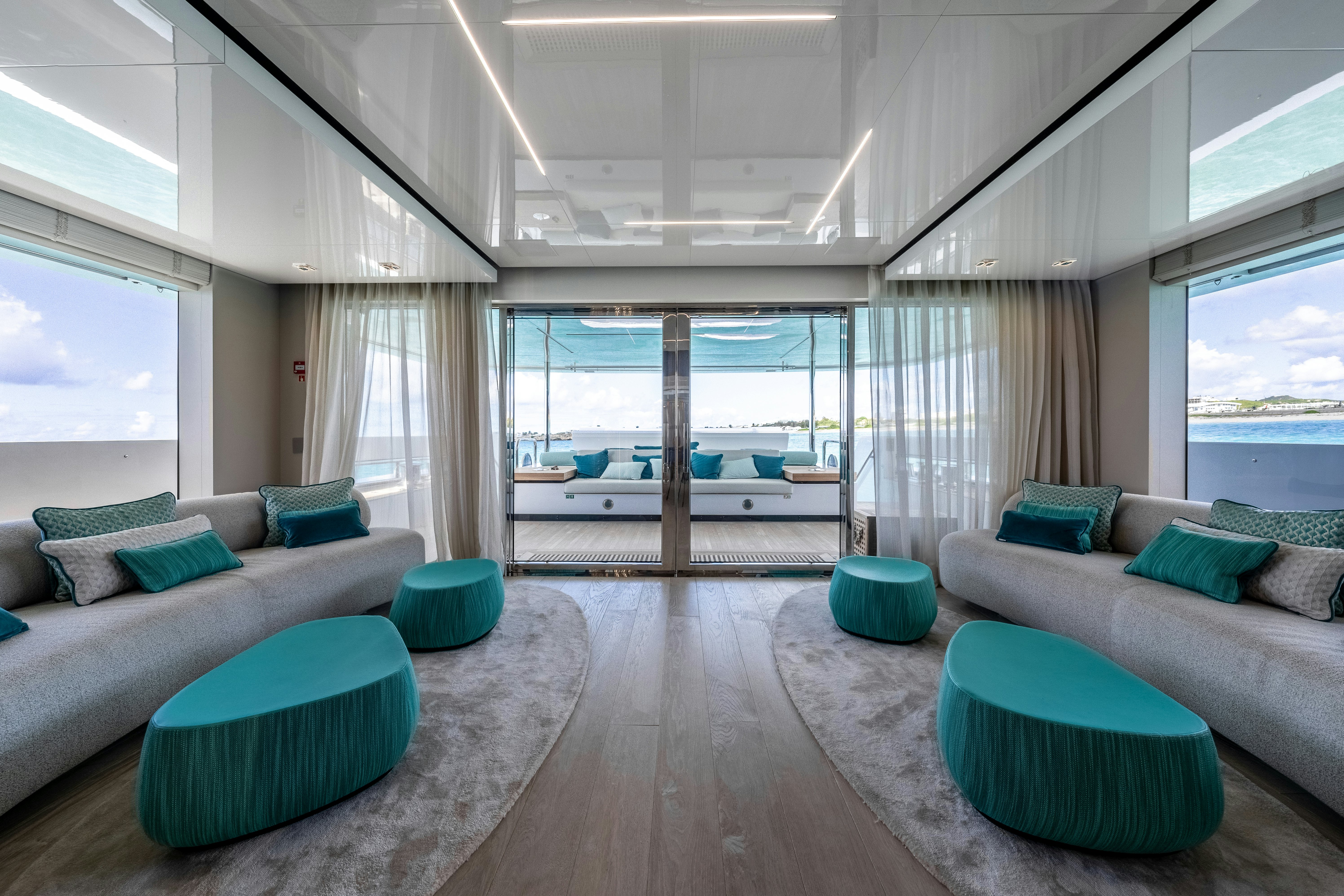 a living room with a large window aboard EMOCEAN Yacht for Sale