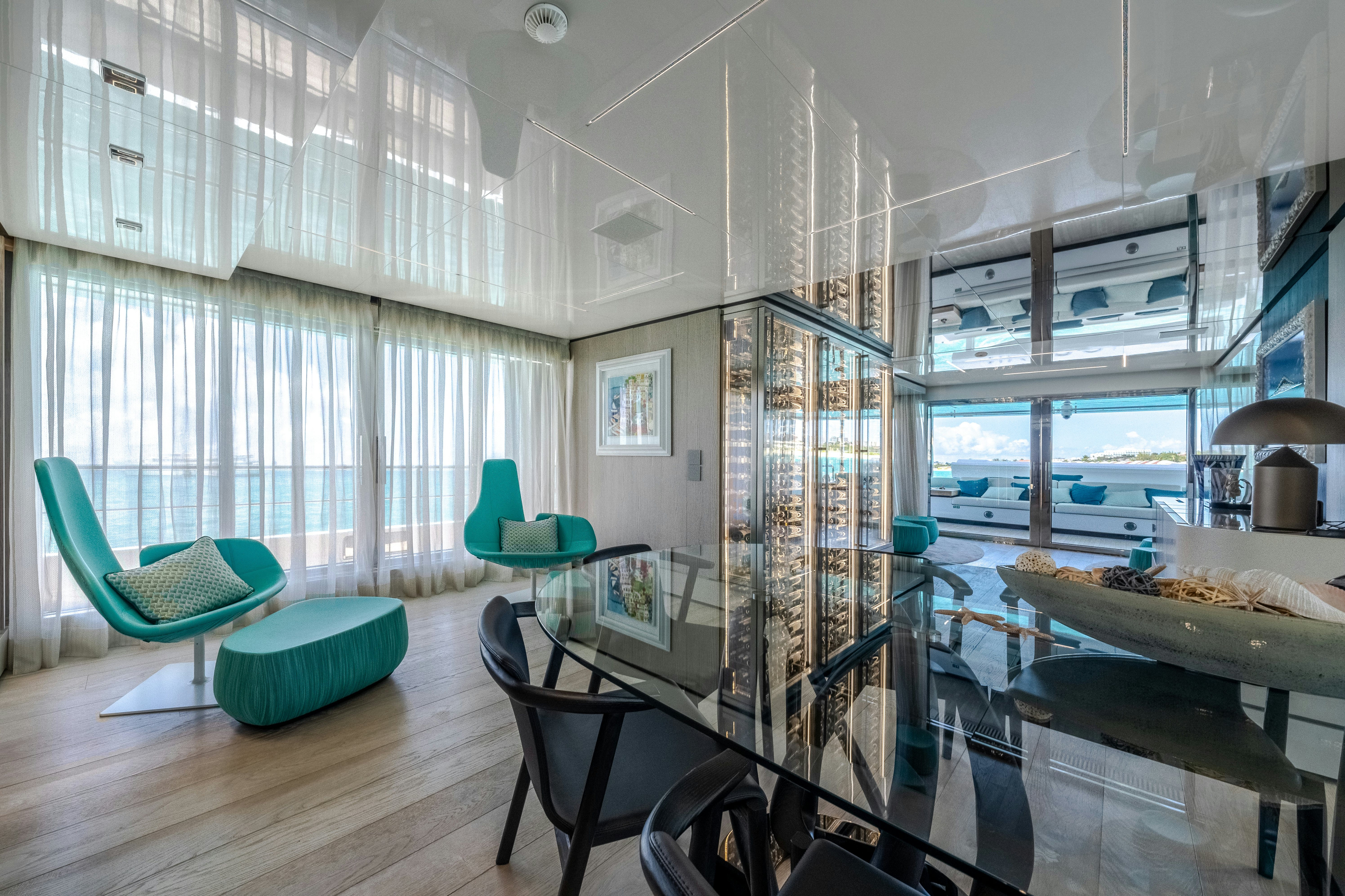 a room with a table chairs and a window aboard EMOCEAN Yacht for Sale