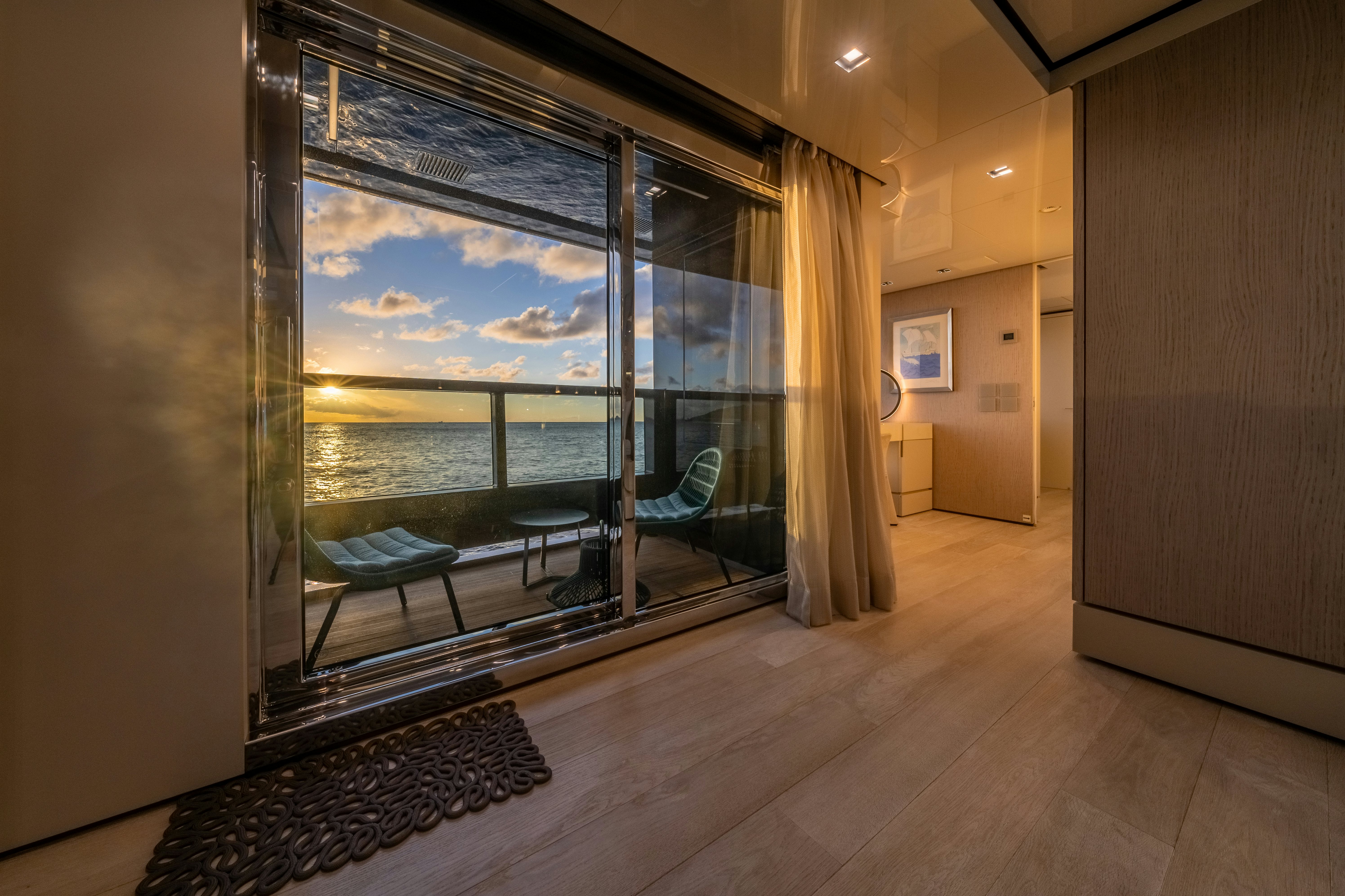 a room with a large window and a table and chairs aboard EMOCEAN Yacht for Sale
