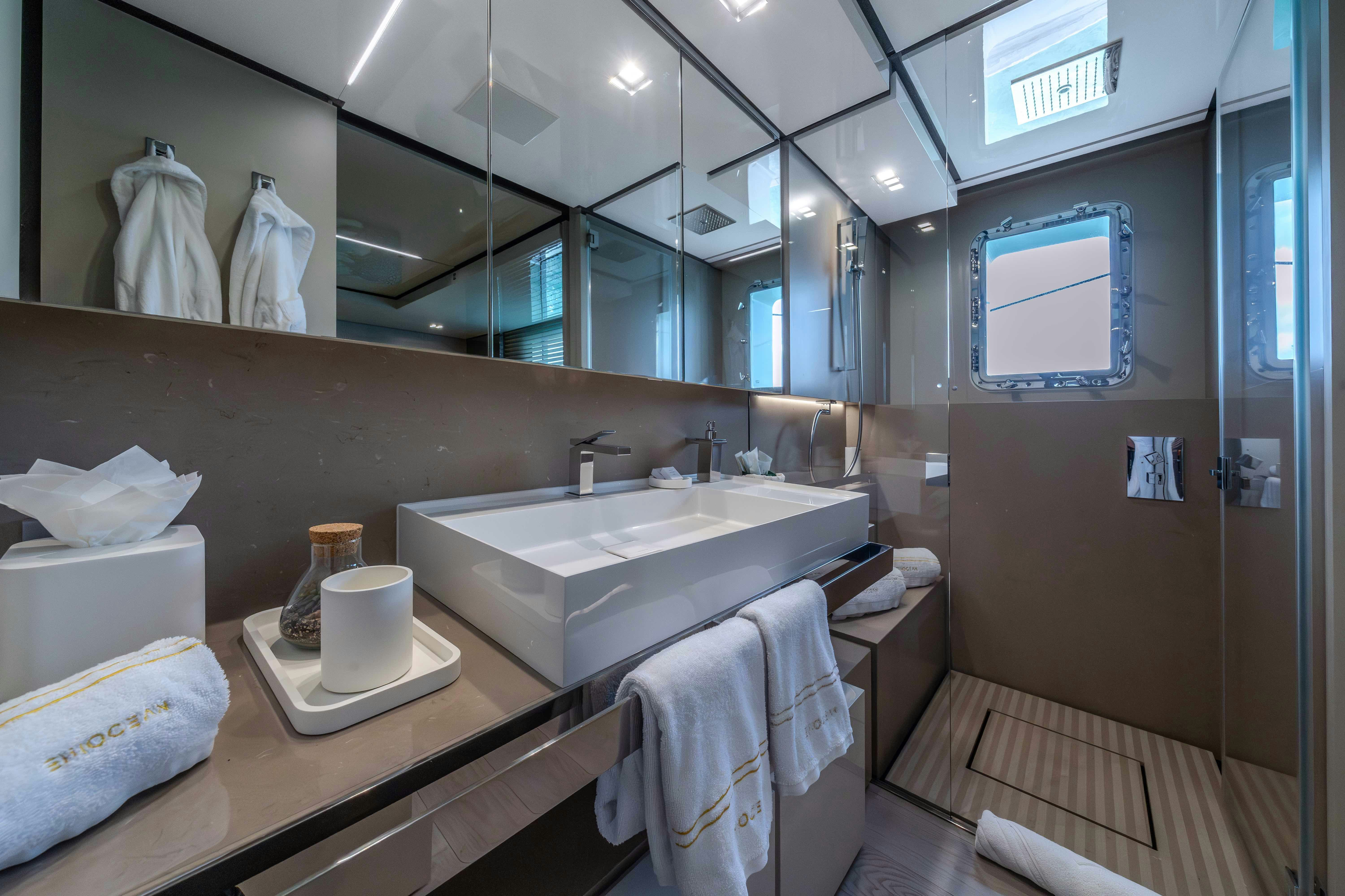 a bathroom with a large mirror aboard EMOCEAN Yacht for Sale