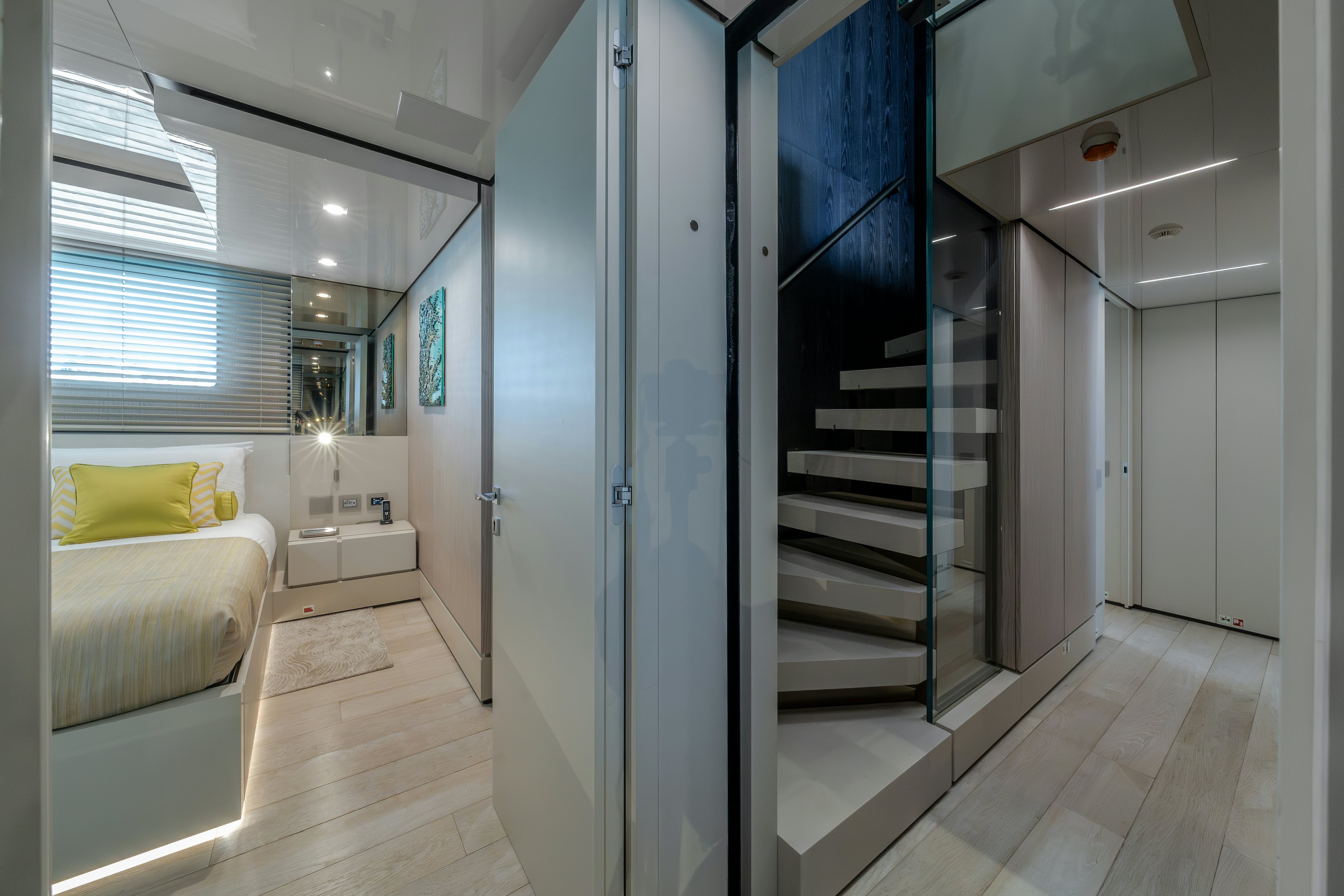 a modern bedroom with a glass door aboard EMOCEAN Yacht for Sale