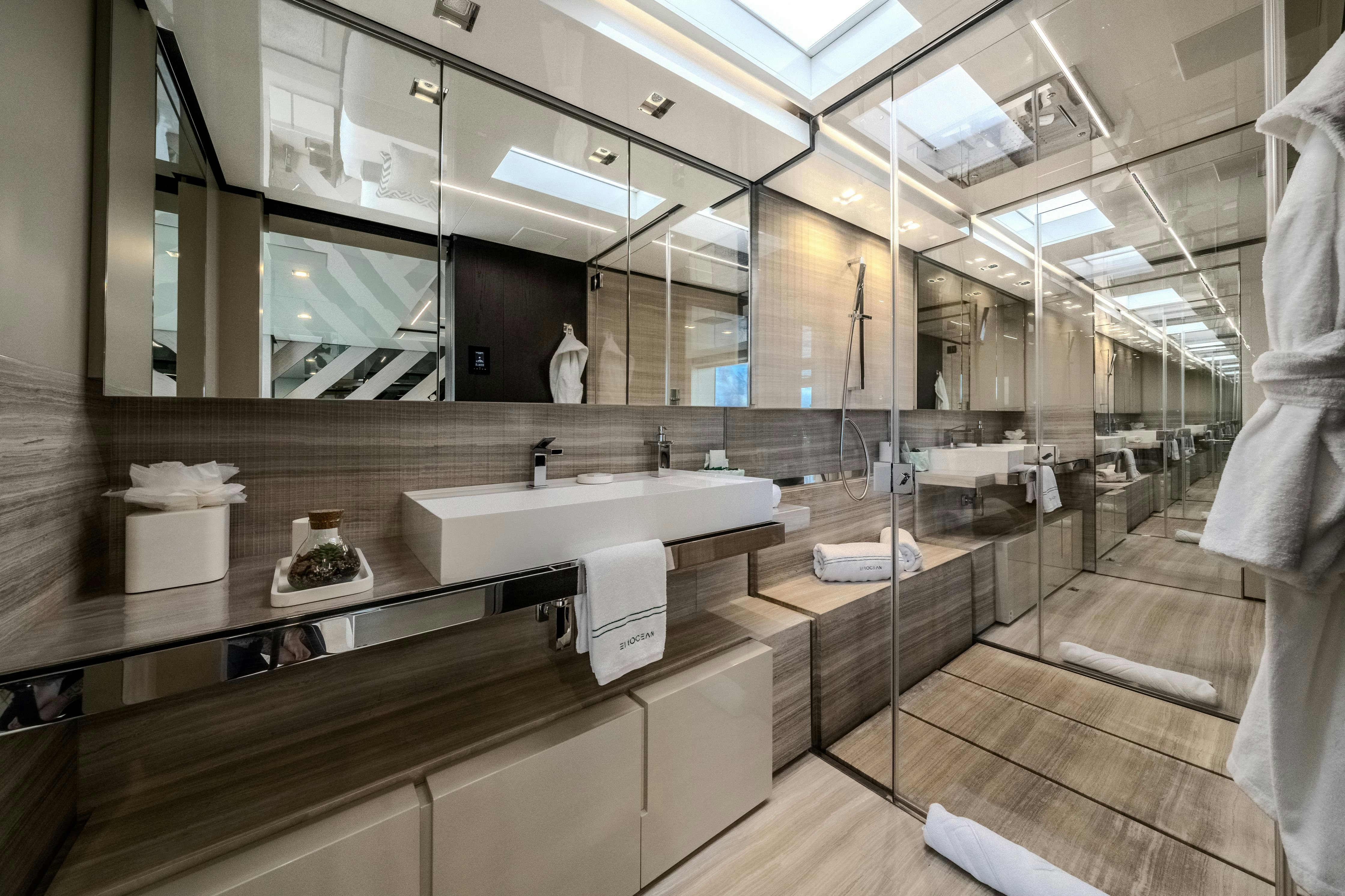 a bathroom with a large mirror aboard EMOCEAN Yacht for Sale
