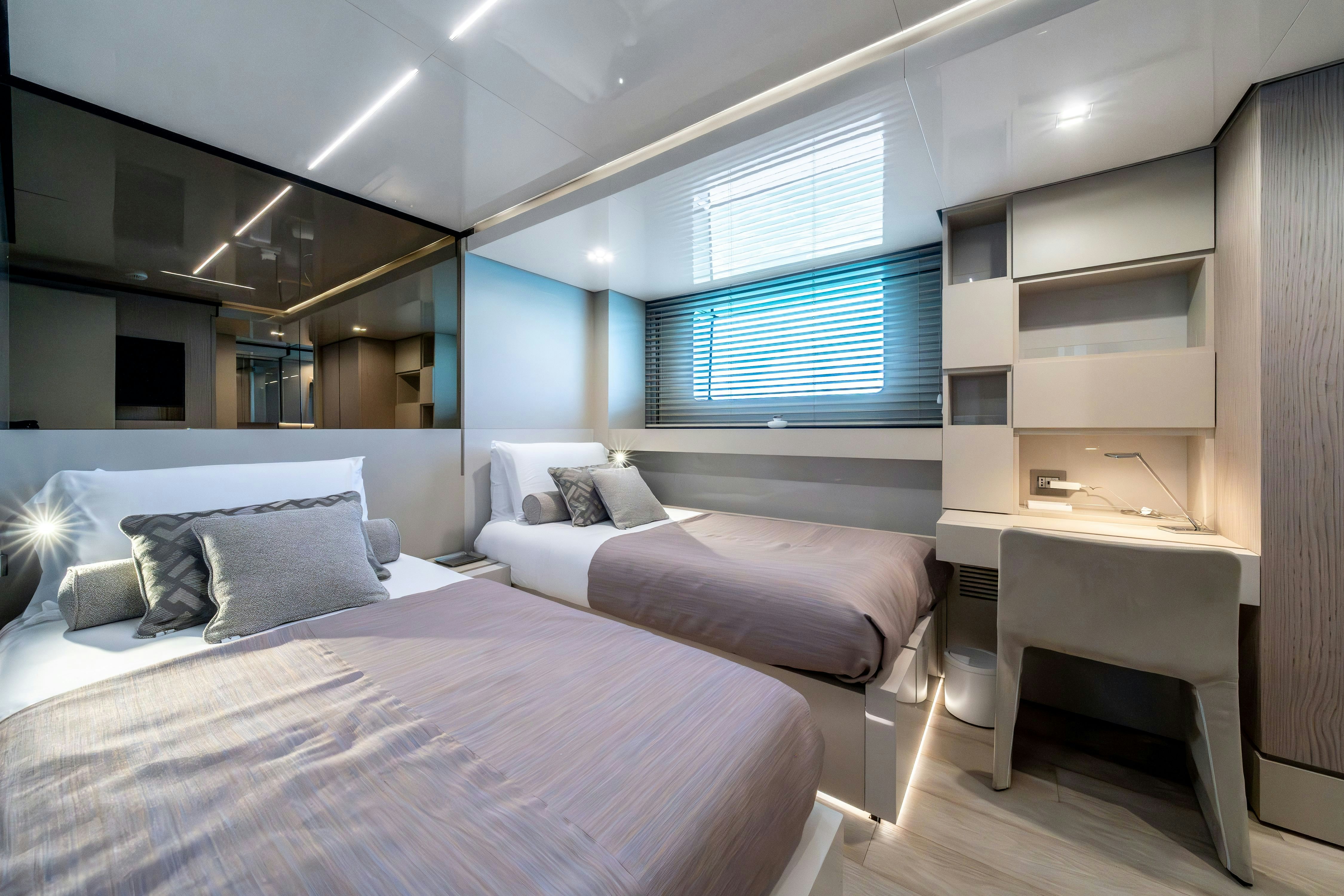 a room with a bed and a desk aboard EMOCEAN Yacht for Sale