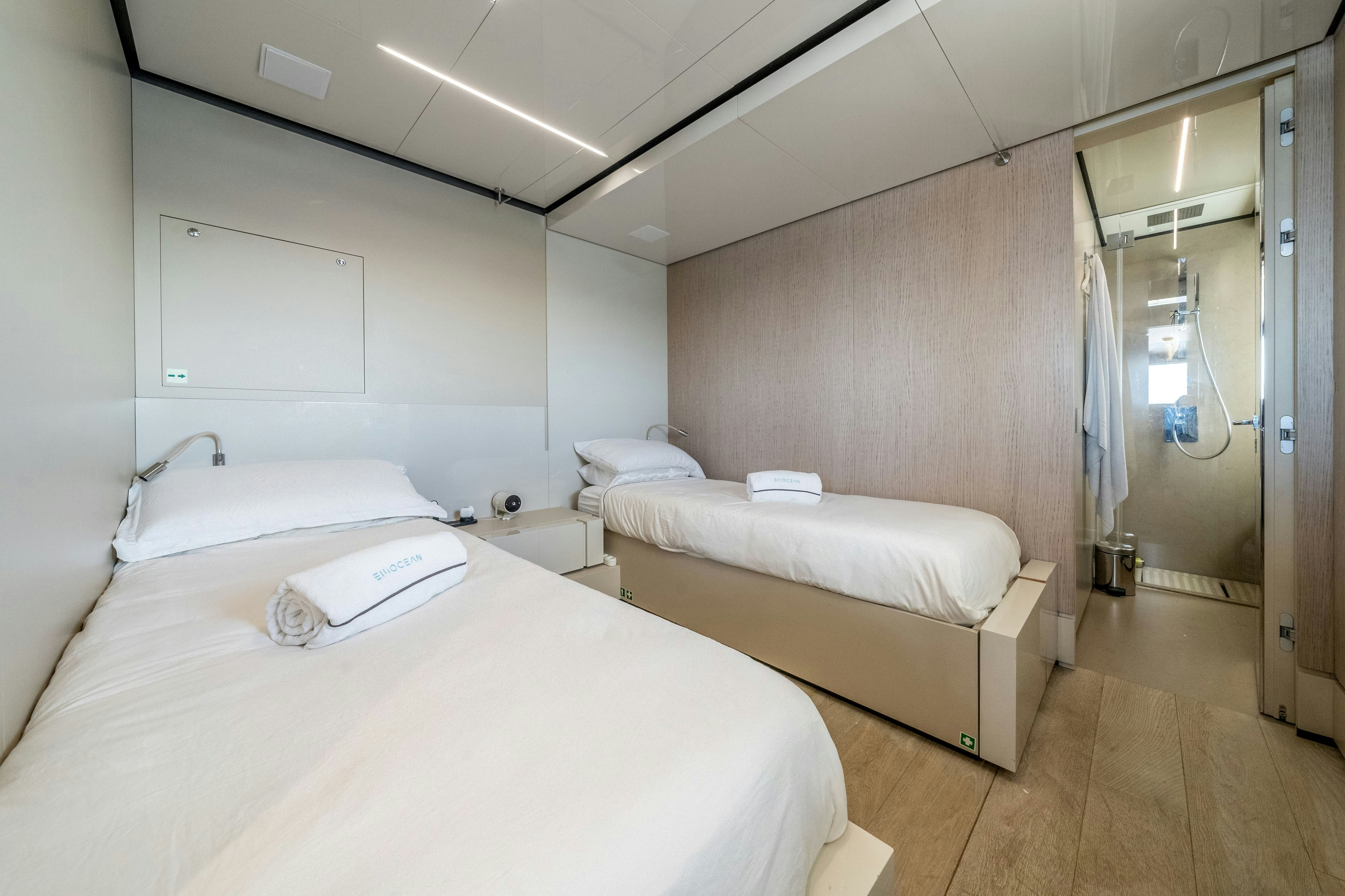 a room with two beds aboard EMOCEAN Yacht for Sale