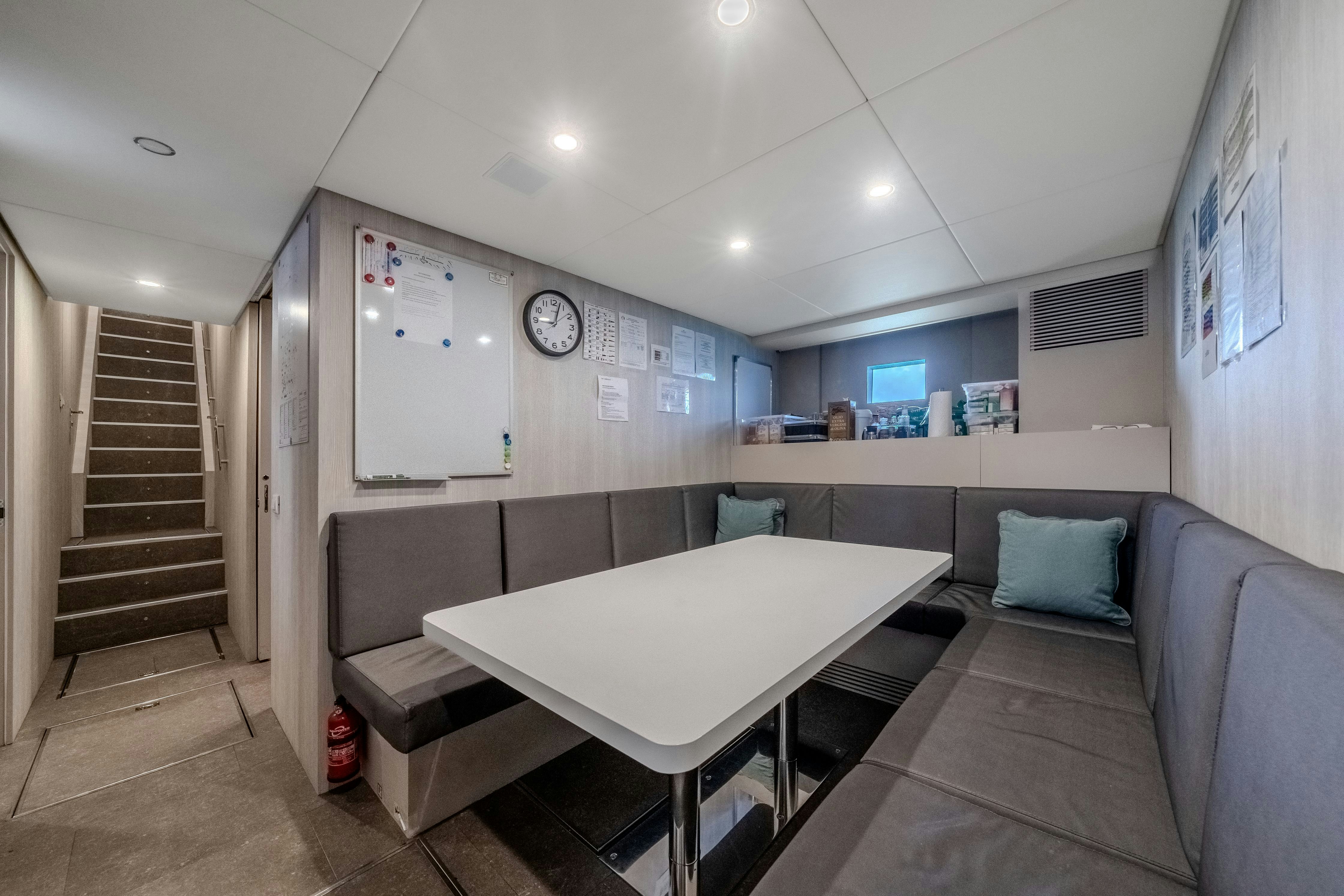 a room with a couch and a table aboard EMOCEAN Yacht for Sale