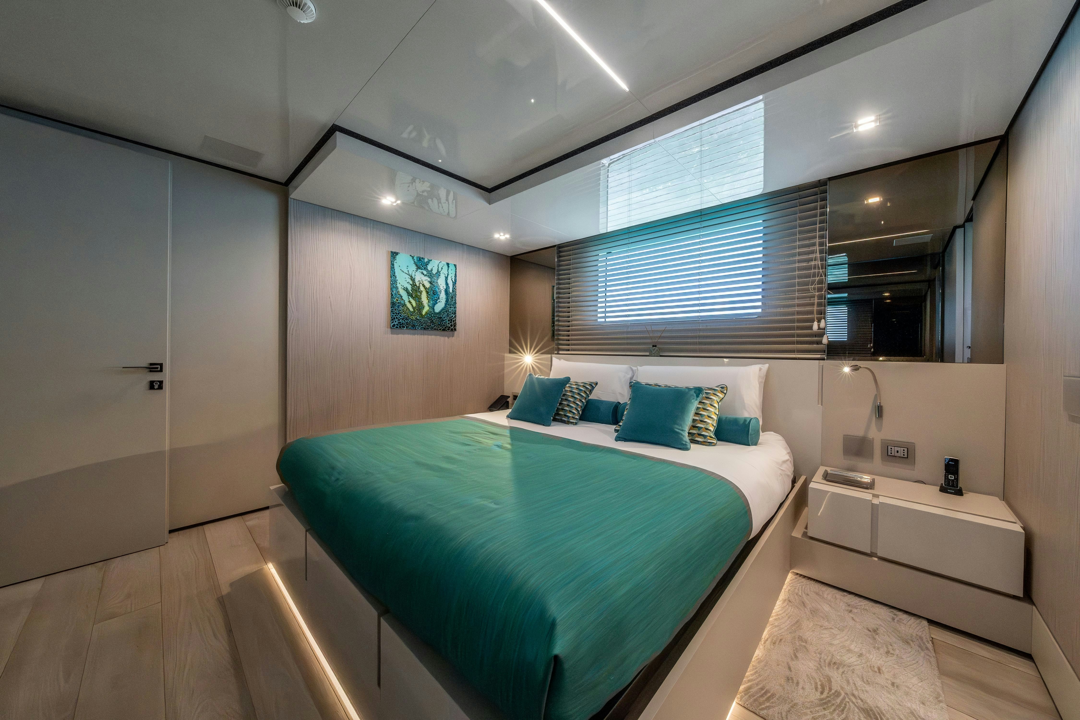 a bedroom with a bed and a mirror aboard EMOCEAN Yacht for Sale