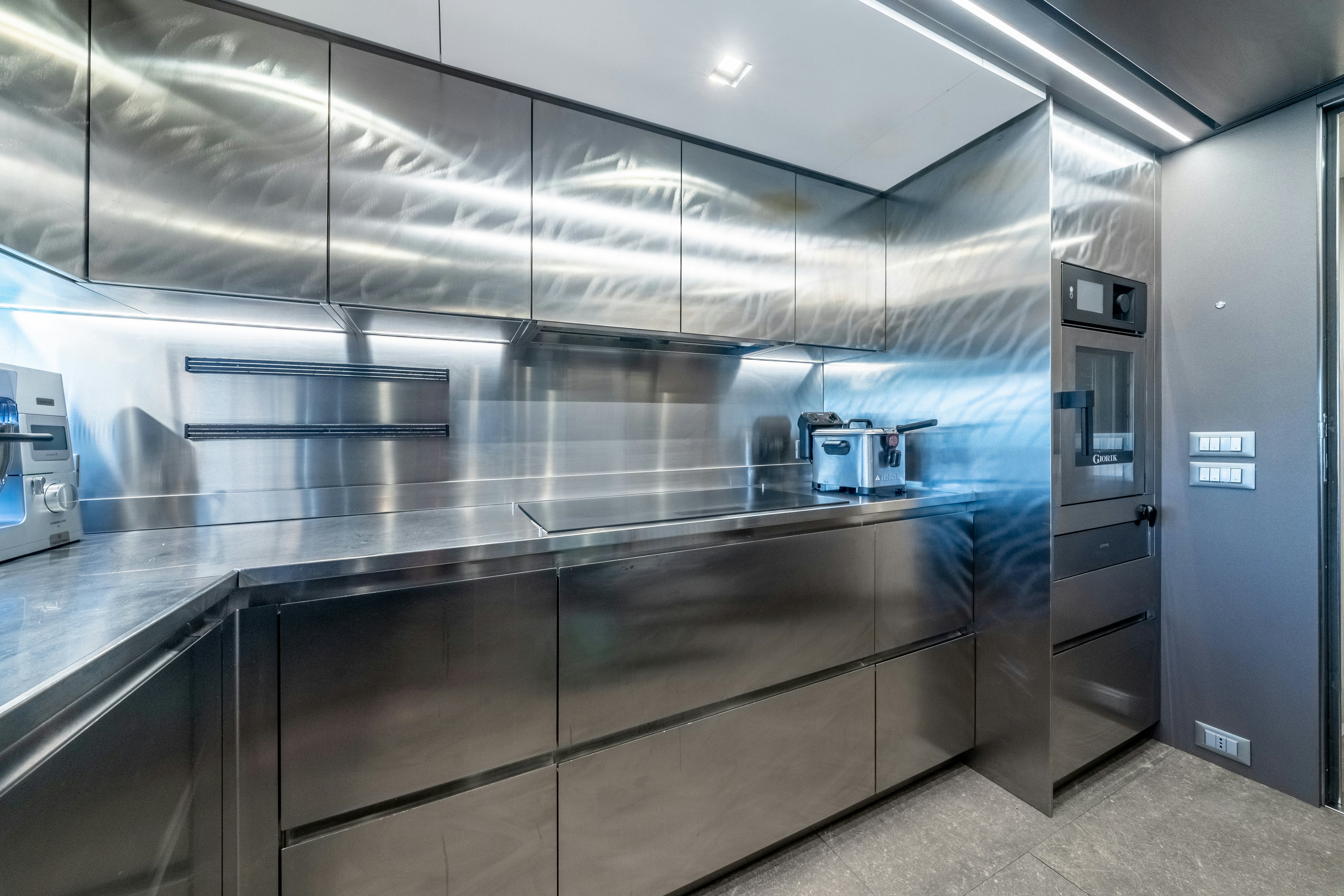 a large kitchen with stainless steel appliances aboard EMOCEAN Yacht for Sale