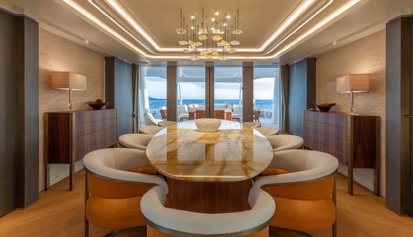 a large living room with a large dining table aboard MOONSTONE Yacht for Sale