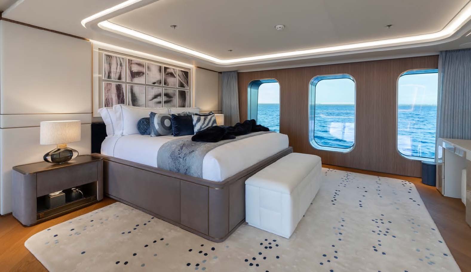a bedroom with a bed and a desk aboard MOONSTONE Yacht for Sale