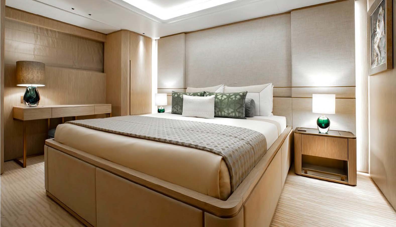 a bed with a lamp on it aboard MOONSTONE Yacht for Sale