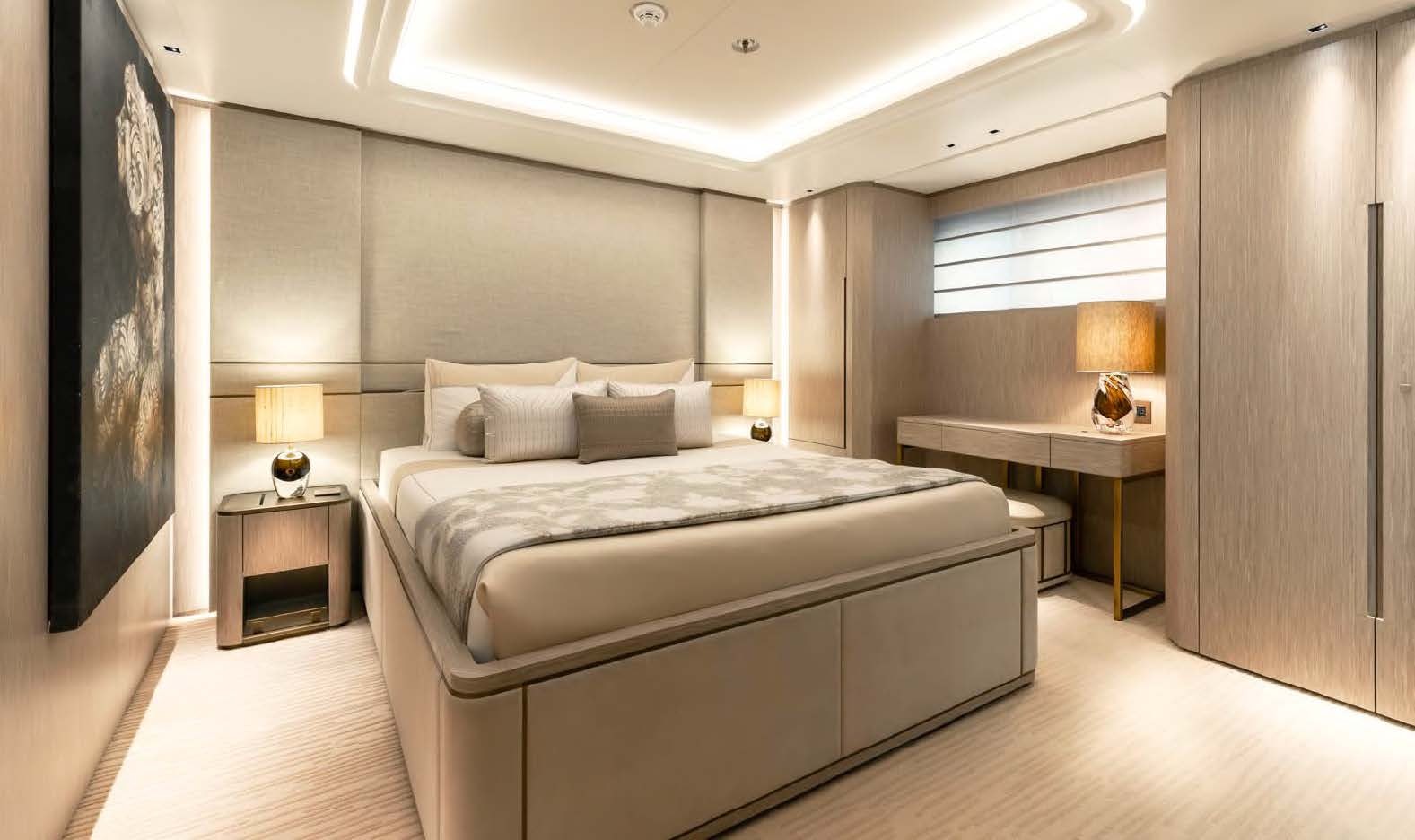 a large bedroom with a bed and a desk aboard MOONSTONE Yacht for Sale