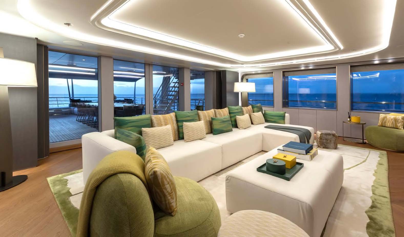 a living room with a couch and a table aboard MOONSTONE Yacht for Sale