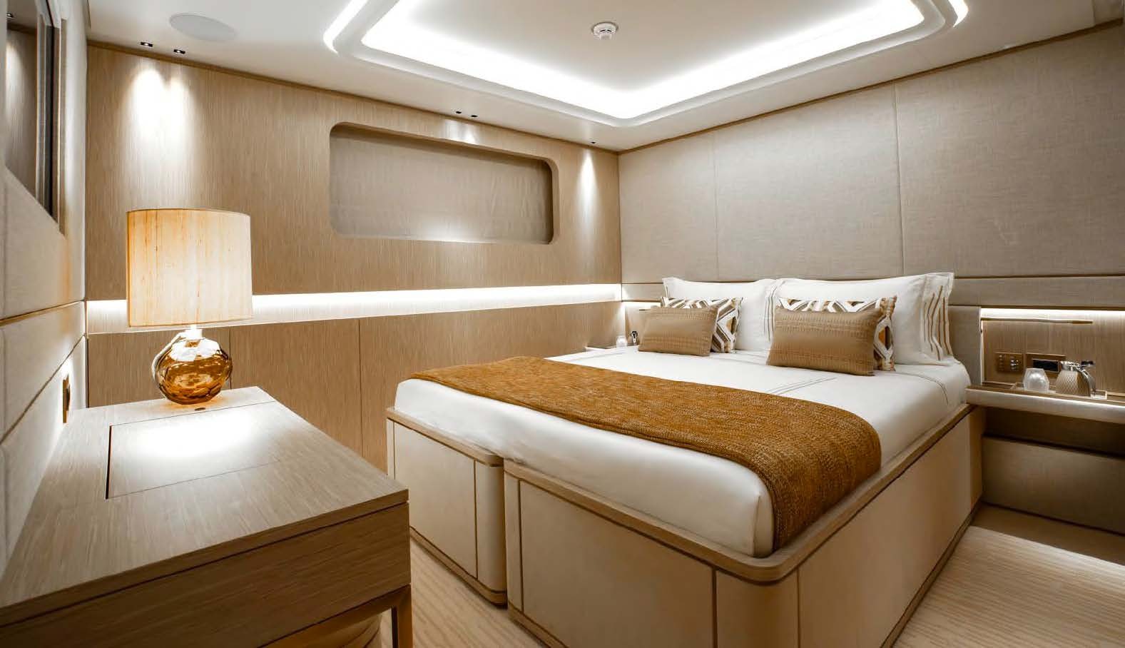 a room with a bed and a lamp aboard MOONSTONE Yacht for Sale