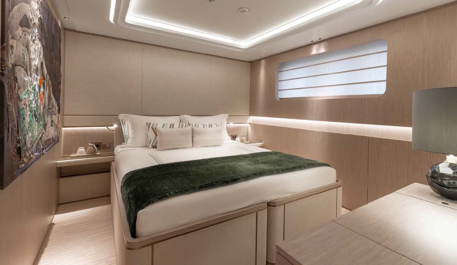 a room with a bed and a lamp aboard MOONSTONE Yacht for Sale