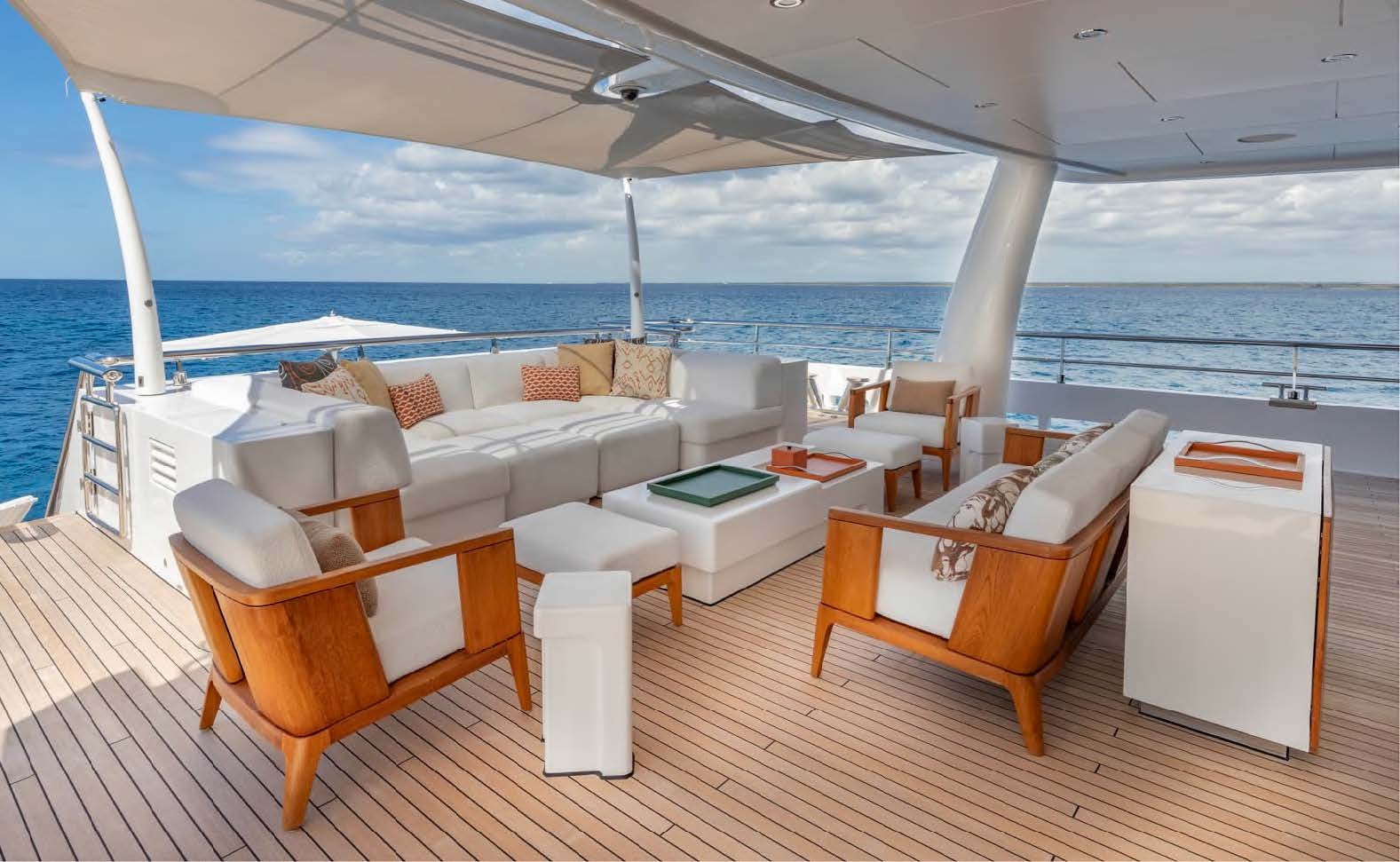 a room with a table chairs and a view of the ocean aboard MOONSTONE Yacht for Sale