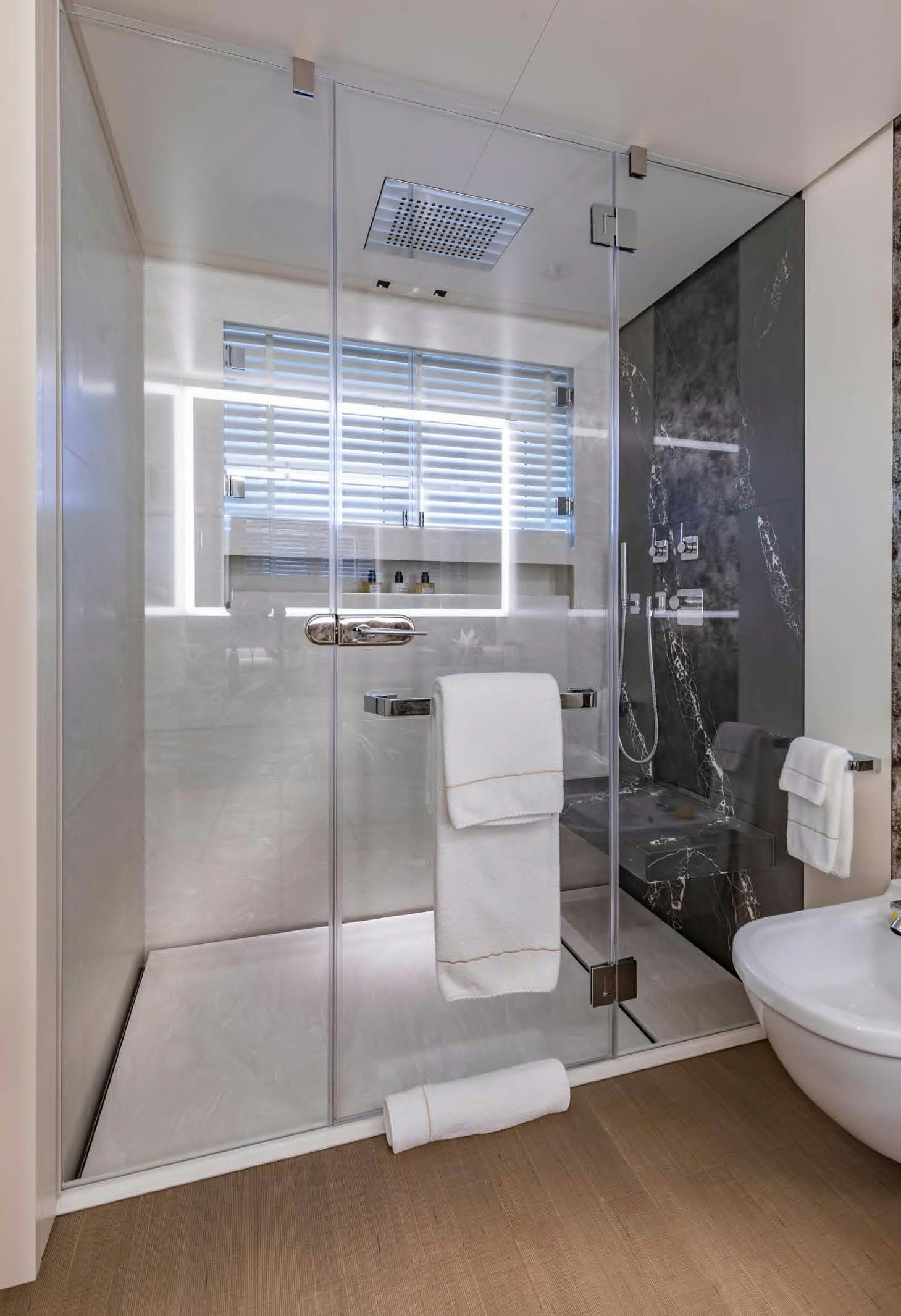 a bathroom with a glass shower aboard MOONSTONE Yacht for Sale