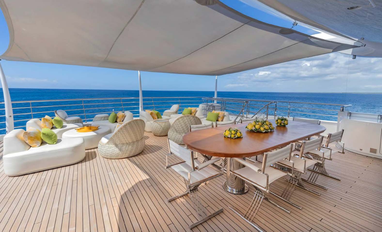 a table with chairs and fruit on it aboard MOONSTONE Yacht for Sale