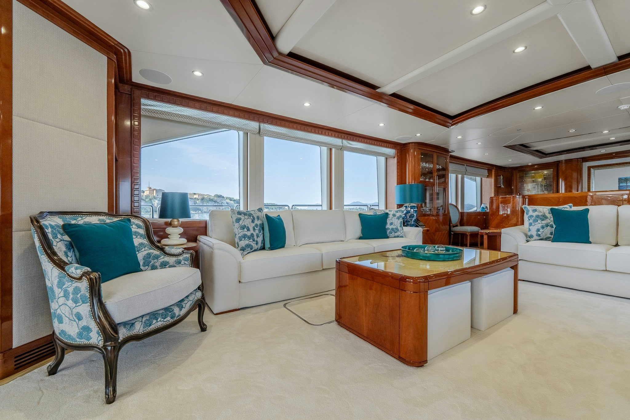 a living room with a couch and a table aboard GRAND CRU Yacht for Sale