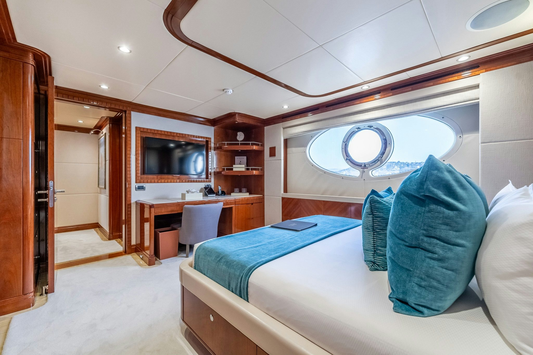 a bedroom with a bed and a desk aboard GRAND CRU Yacht for Sale