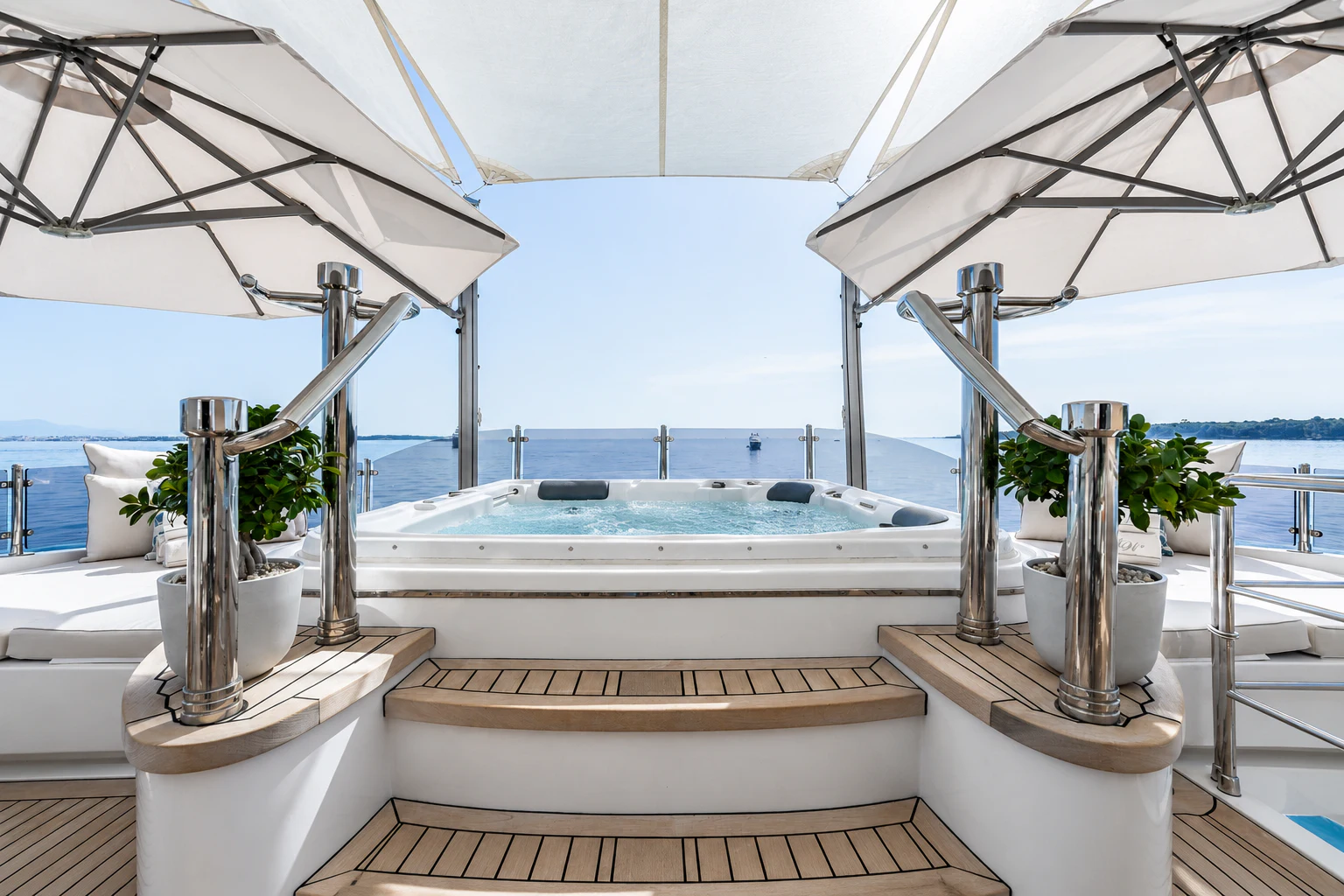 a large white room with a large swimming pool and plants aboard GRAND CRU Yacht for Charter