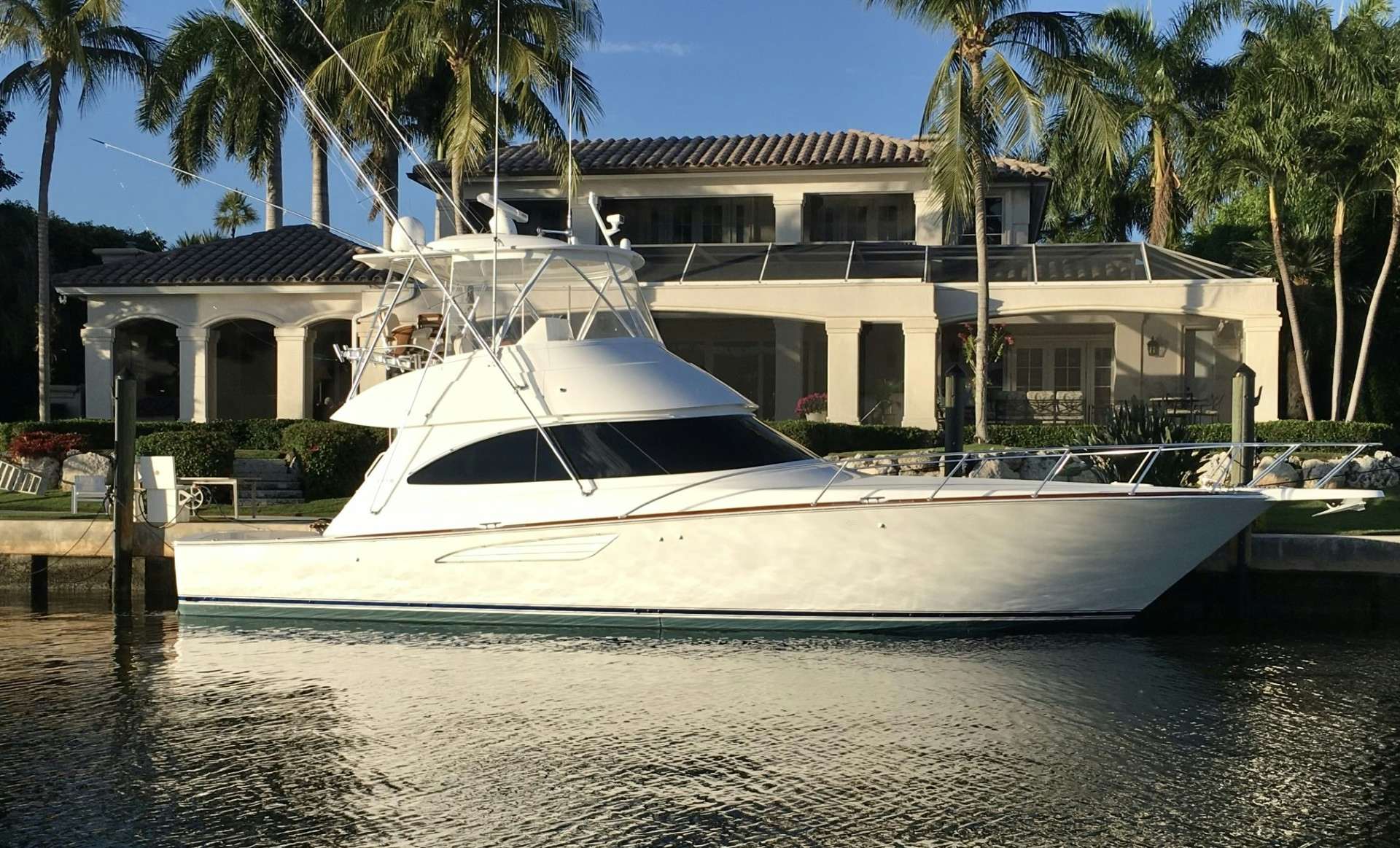 a white boat in a body of water aboard FISHTALES Yacht for Sale