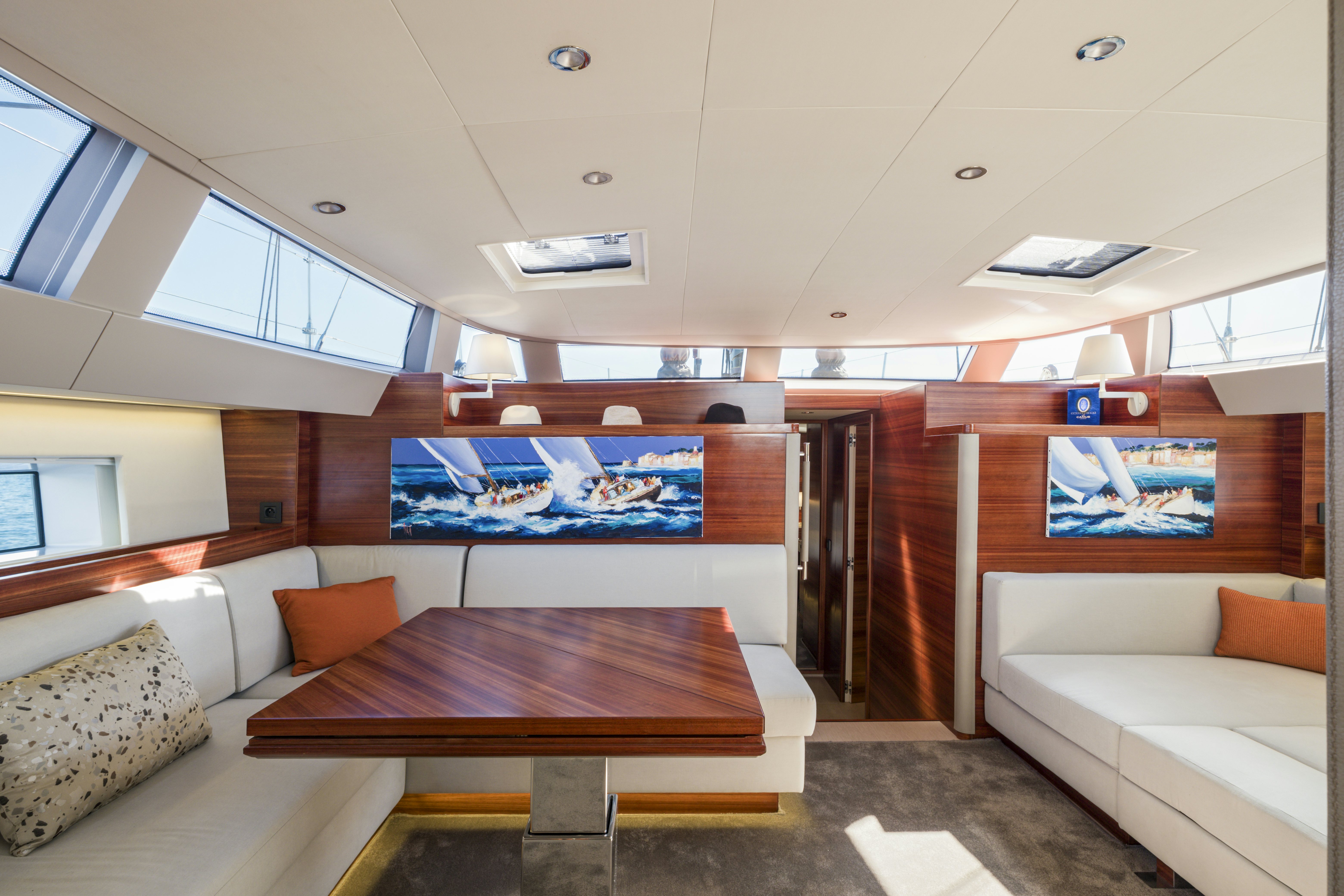 a room with a table and couch aboard DREAM ON Yacht for Sale