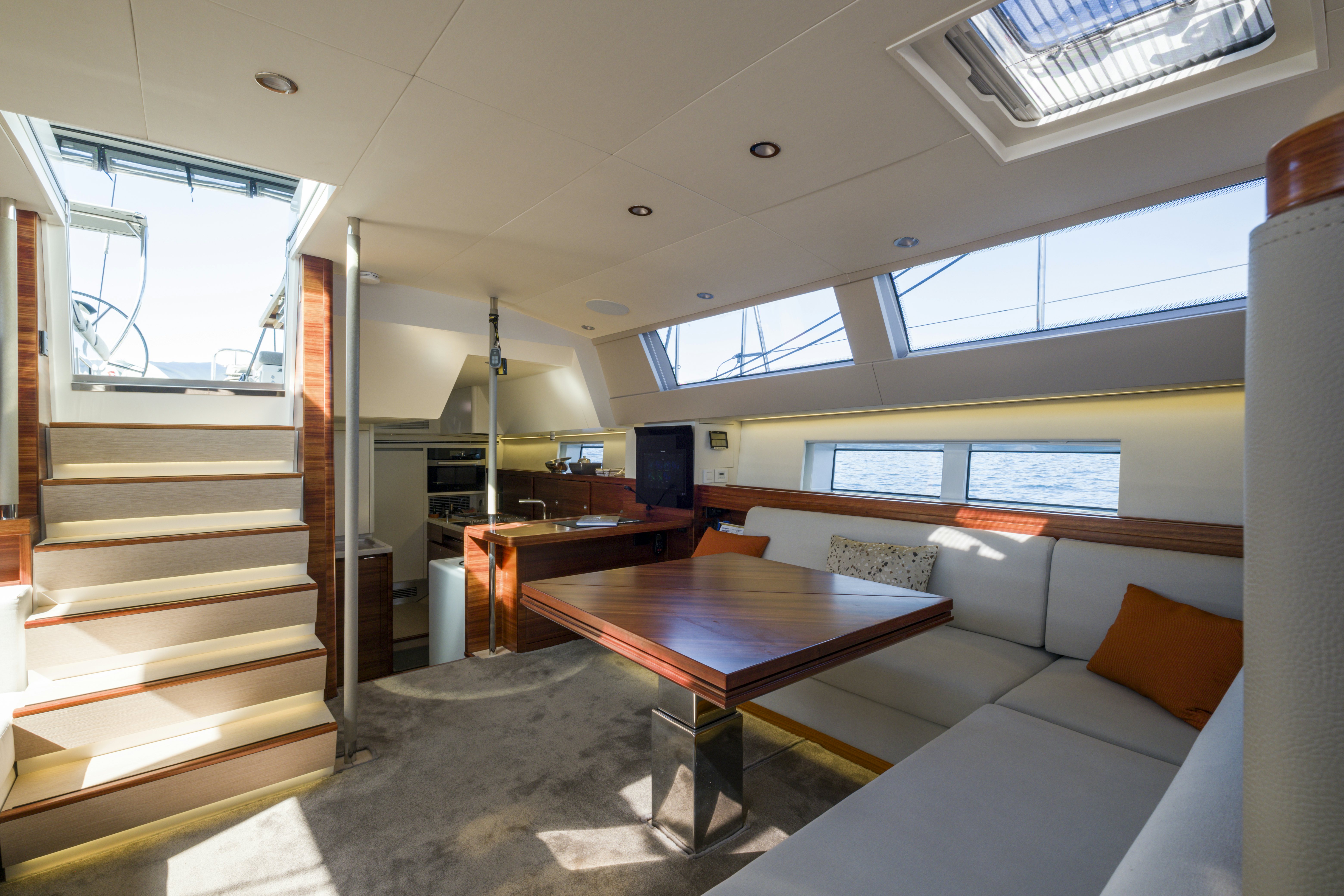 a room with a table and couch aboard DREAM ON Yacht for Sale