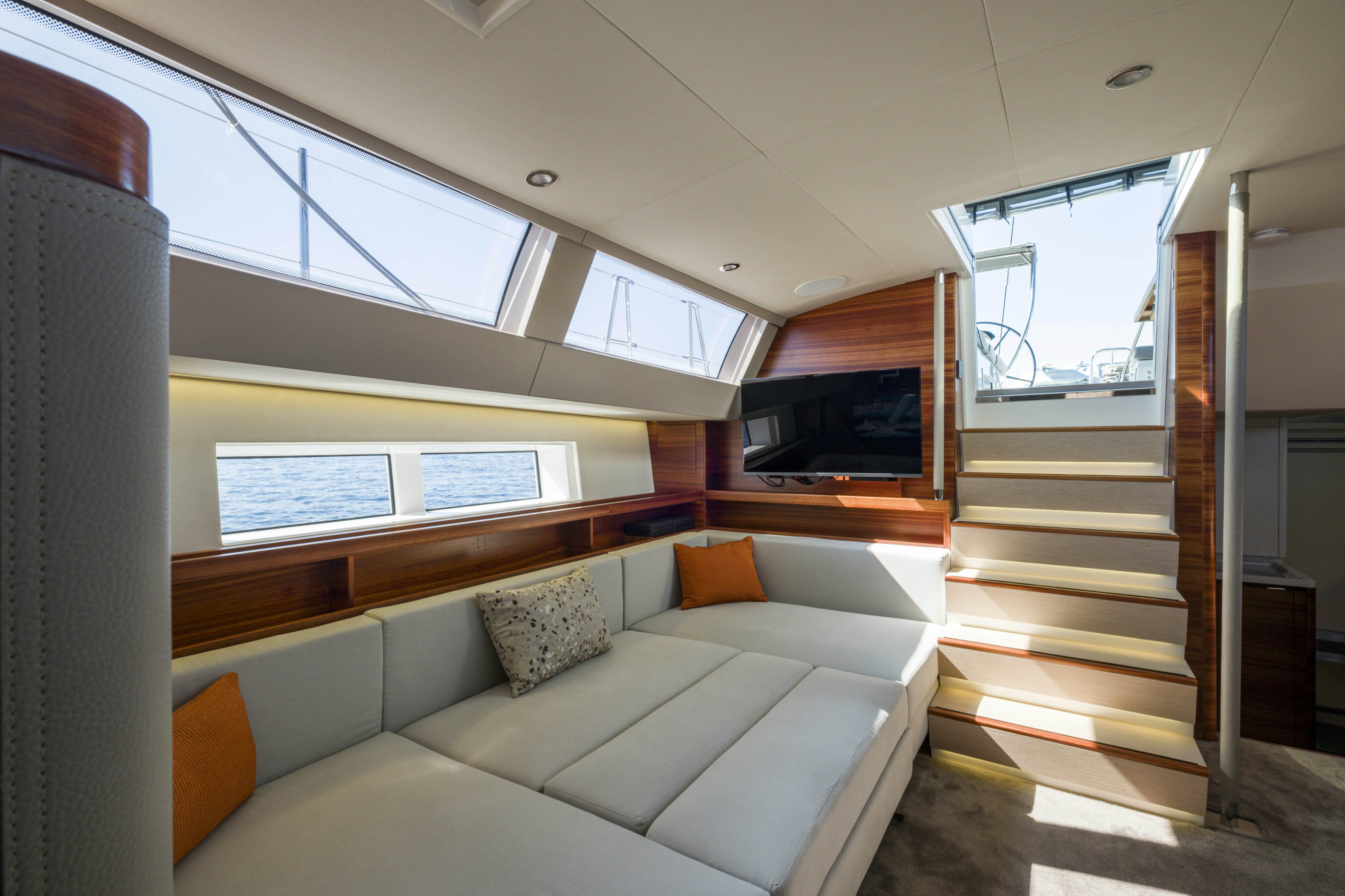 a room with a couch and a television aboard DREAM ON Yacht for Sale