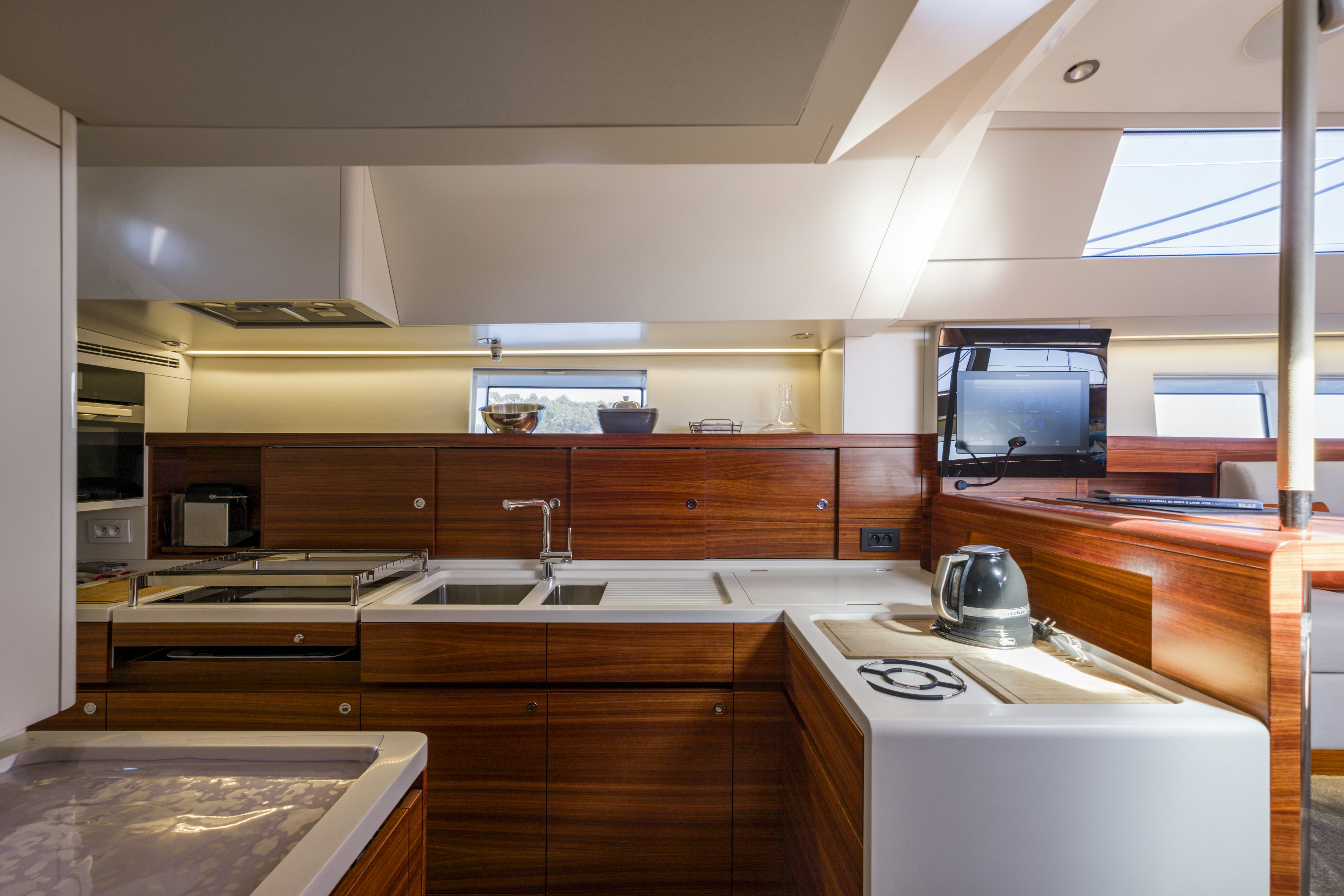 a kitchen with wooden cabinets aboard DREAM ON Yacht for Sale