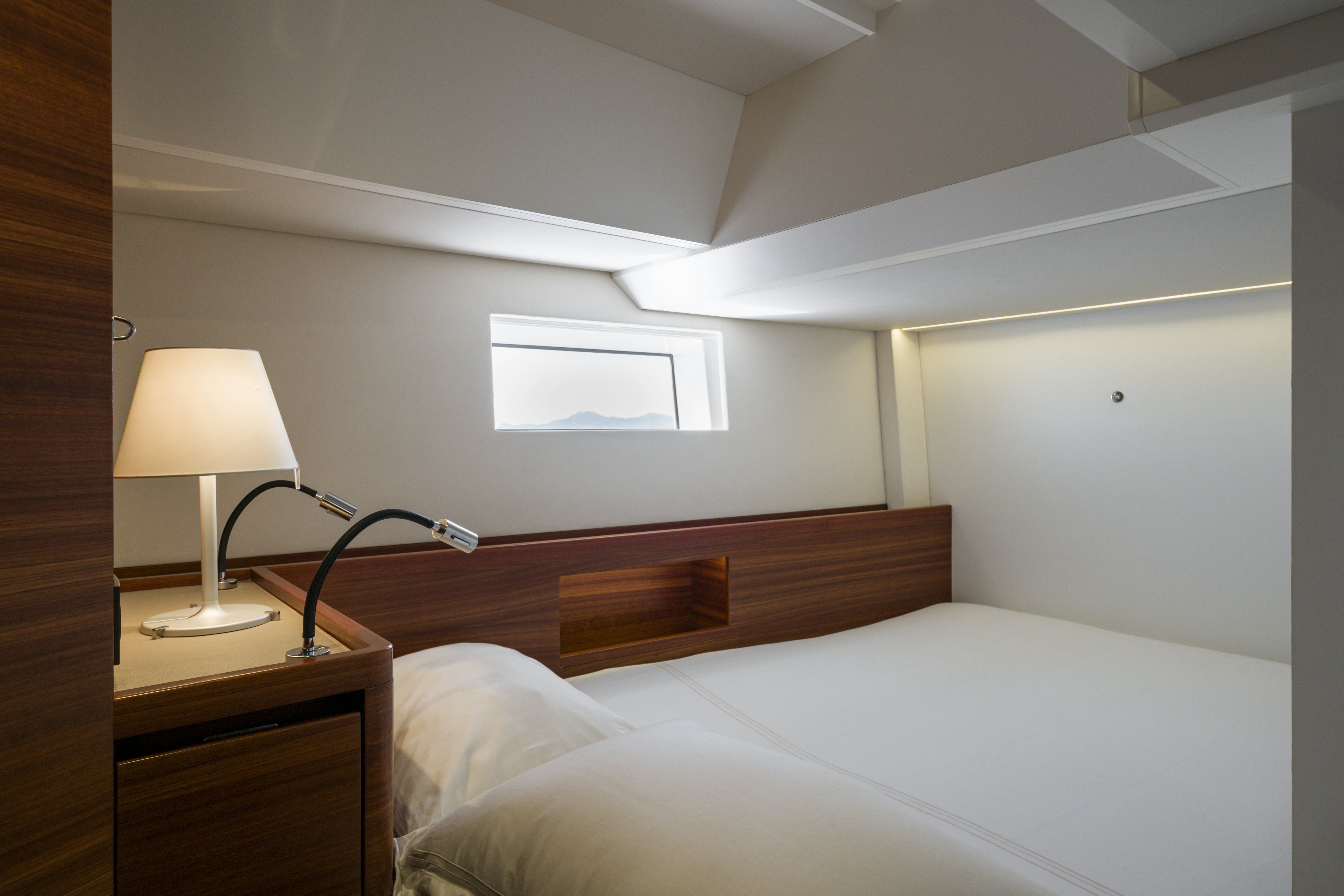 a bed with a lamp on it aboard DREAM ON Yacht for Sale
