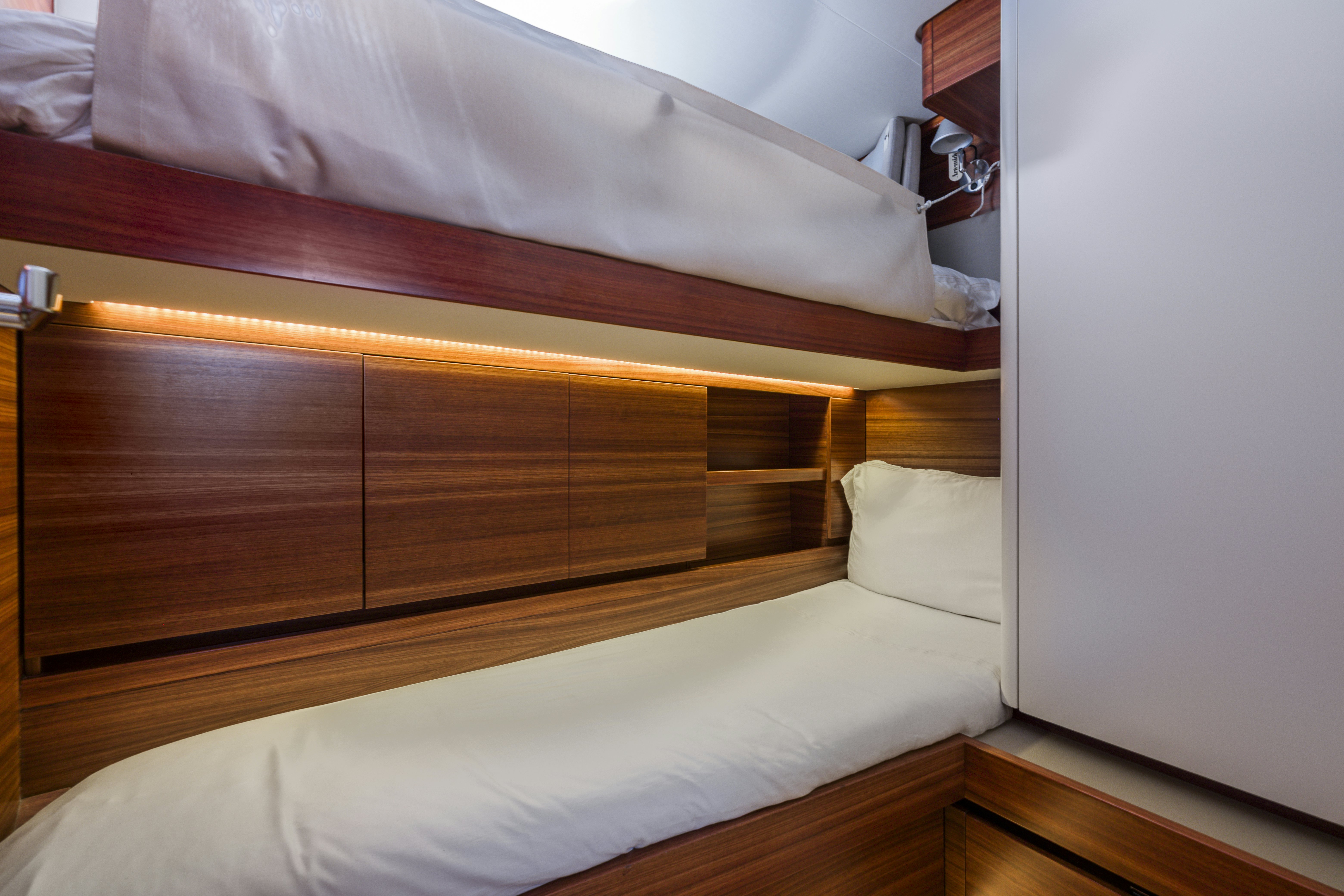 a bed with a wooden headboard aboard DREAM ON Yacht for Sale