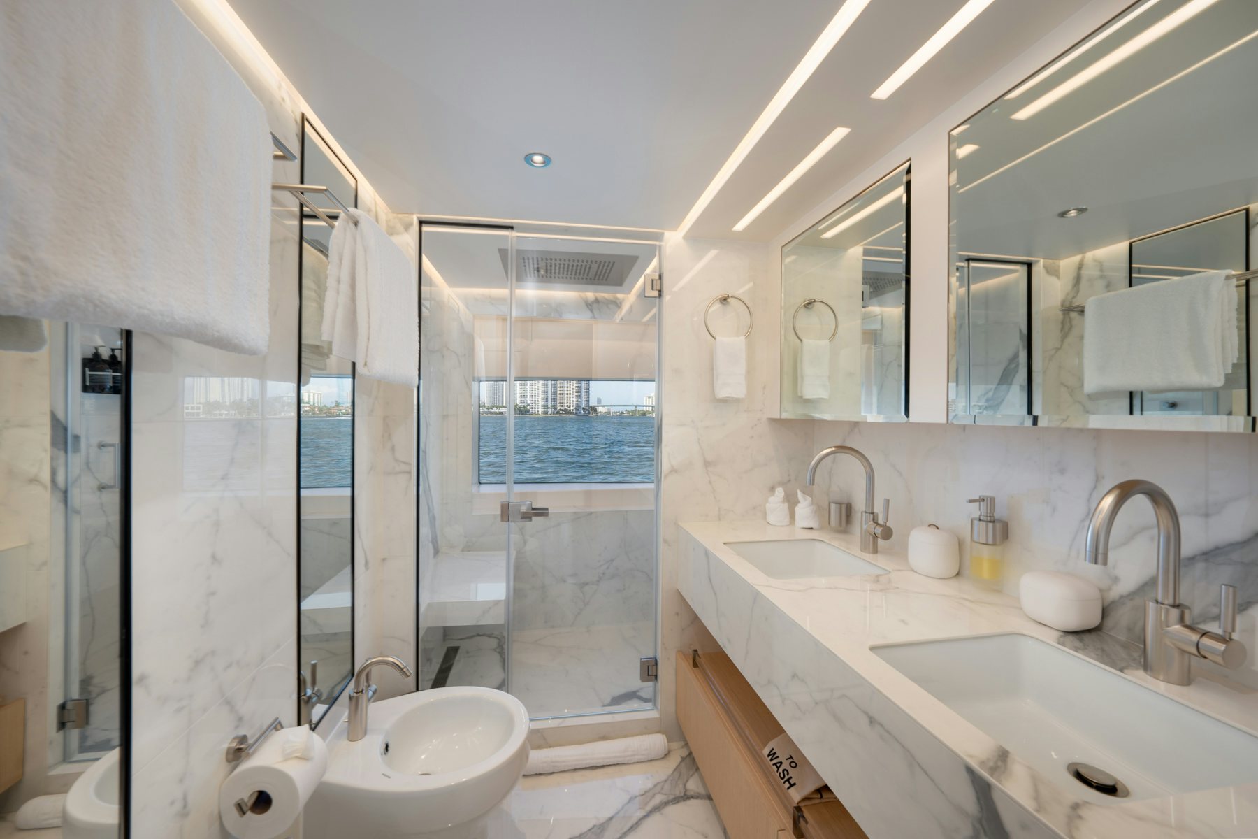 a bathroom with a glass shower aboard SANTOSH Yacht for Sale