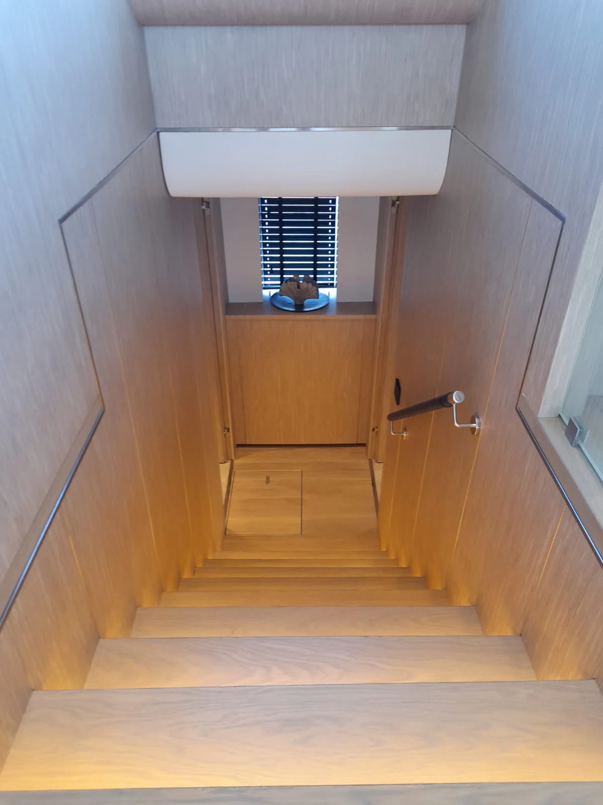 a wooden staircase with a window aboard FLAGSHIP Yacht for Sale