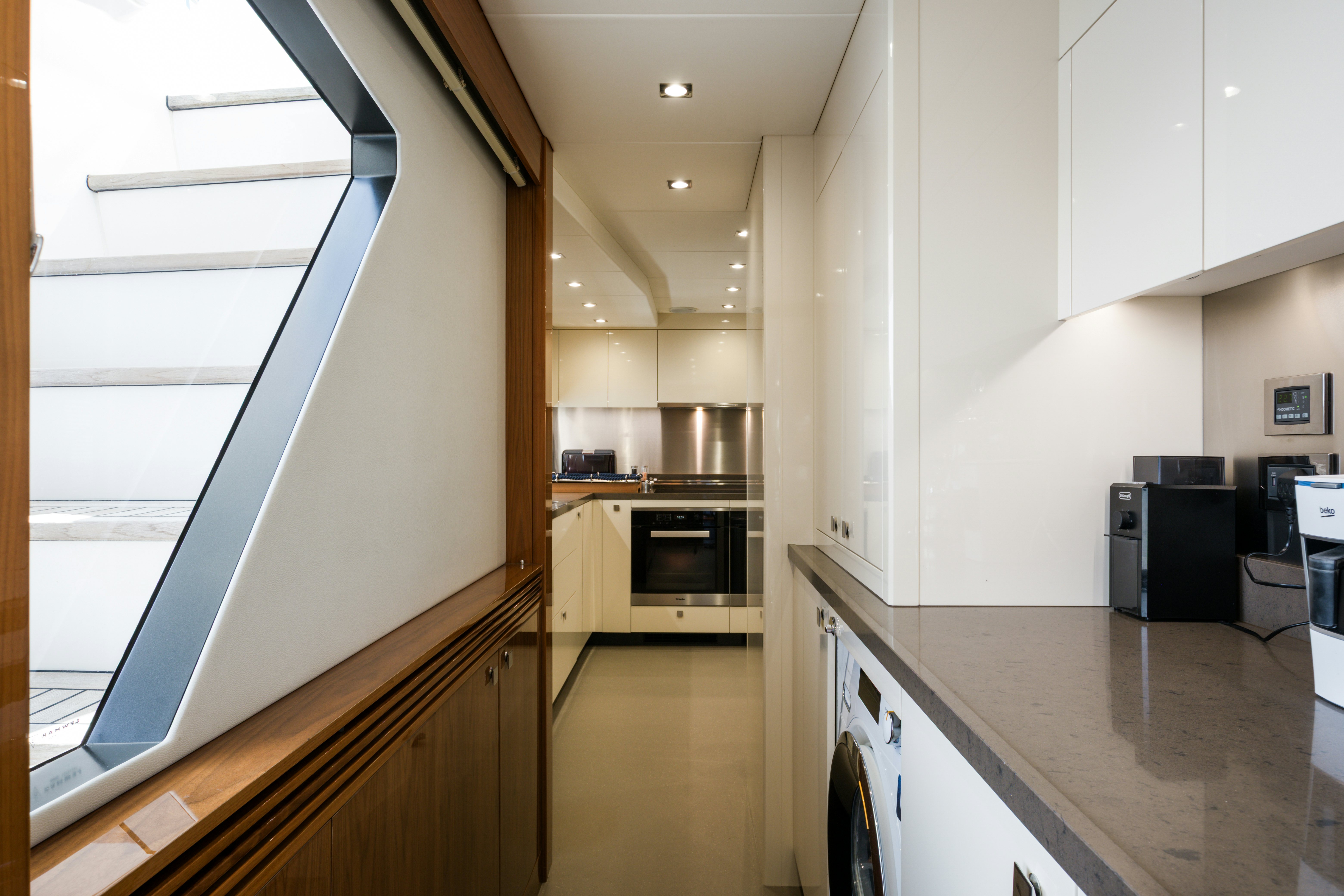 a kitchen with white cabinets aboard MERCY OCEANS Yacht for Sale