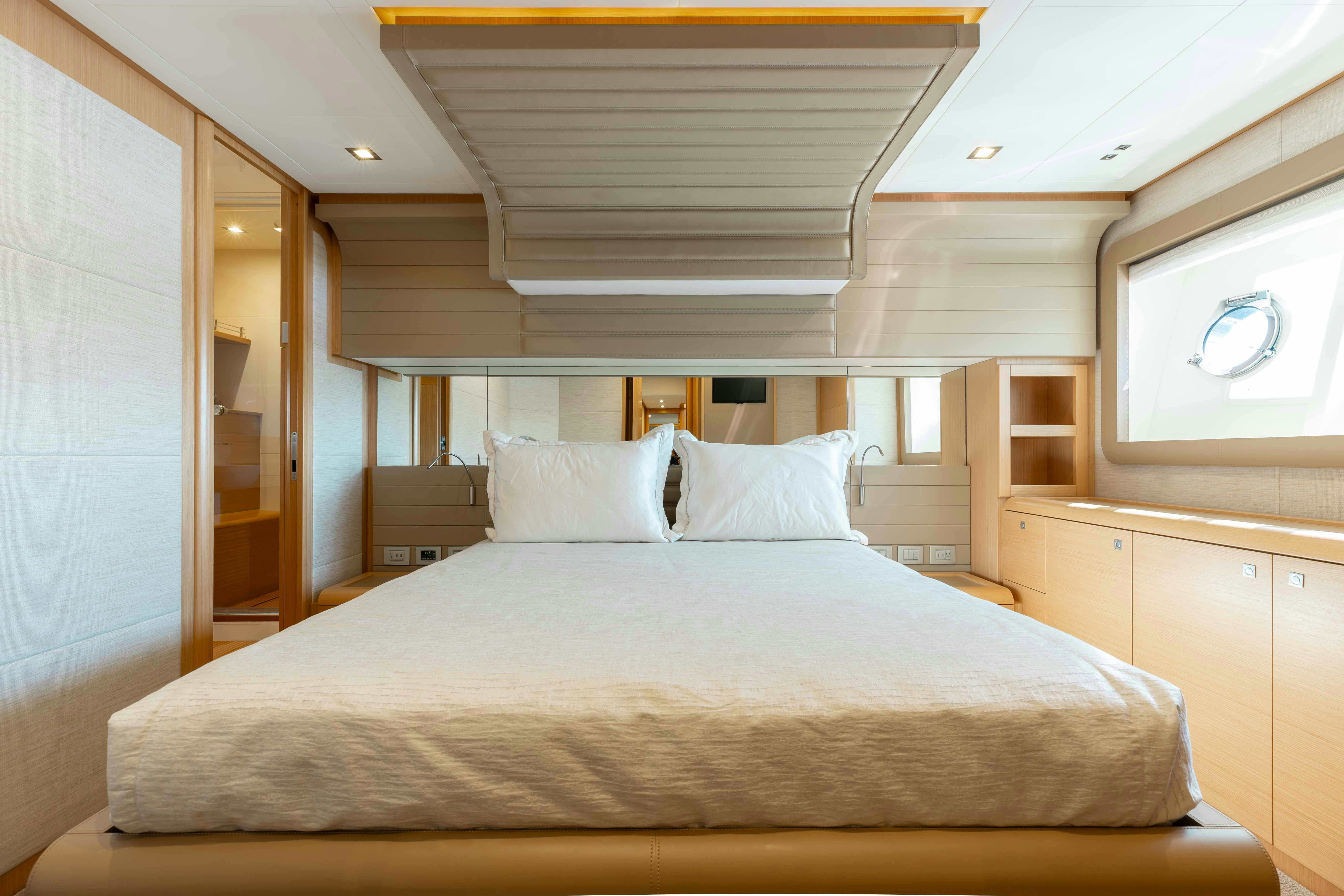 a bed with white sheets aboard LIVING LIFE 3 Yacht for Sale
