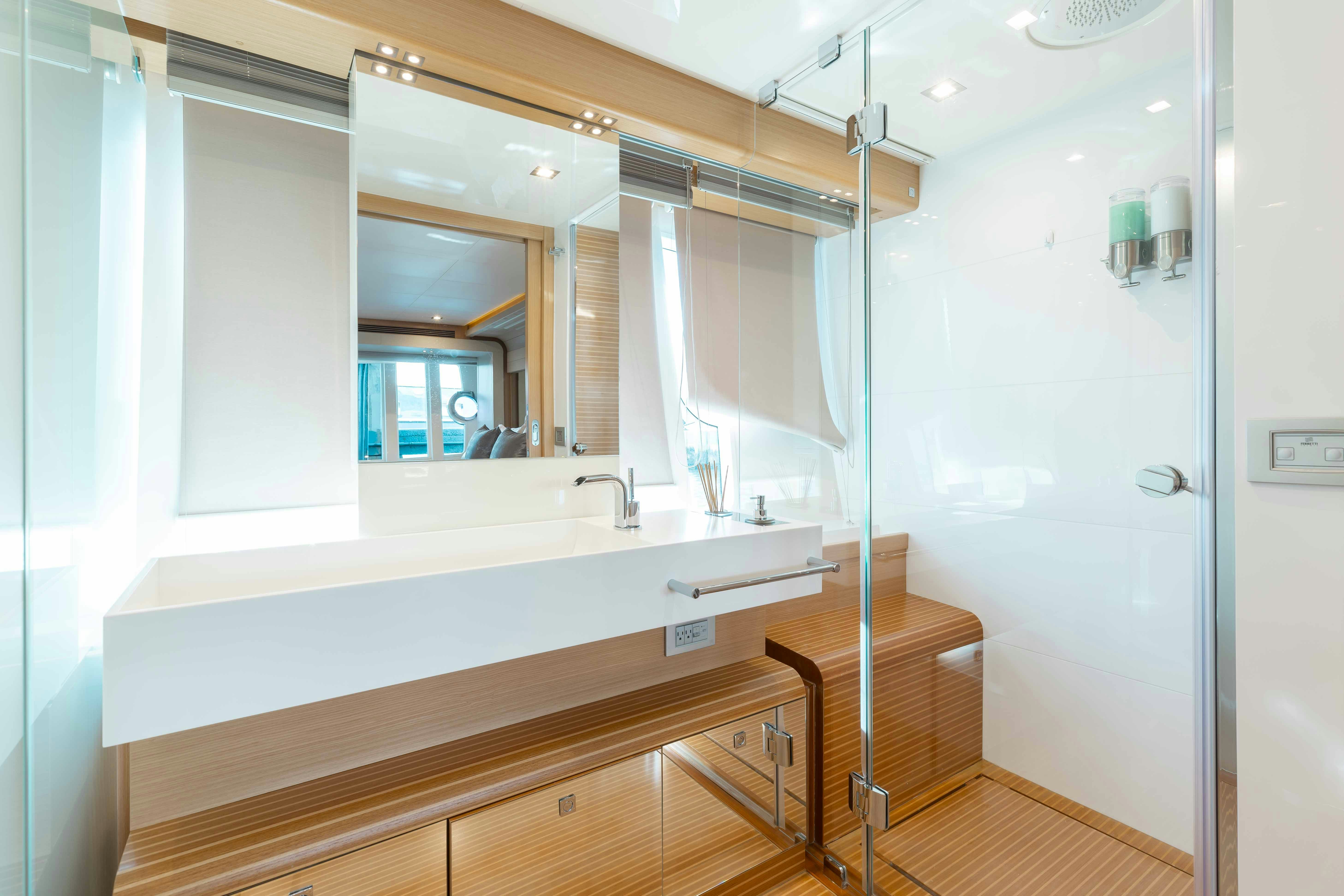 a bathroom with a large mirror aboard LIVING LIFE 3 Yacht for Sale