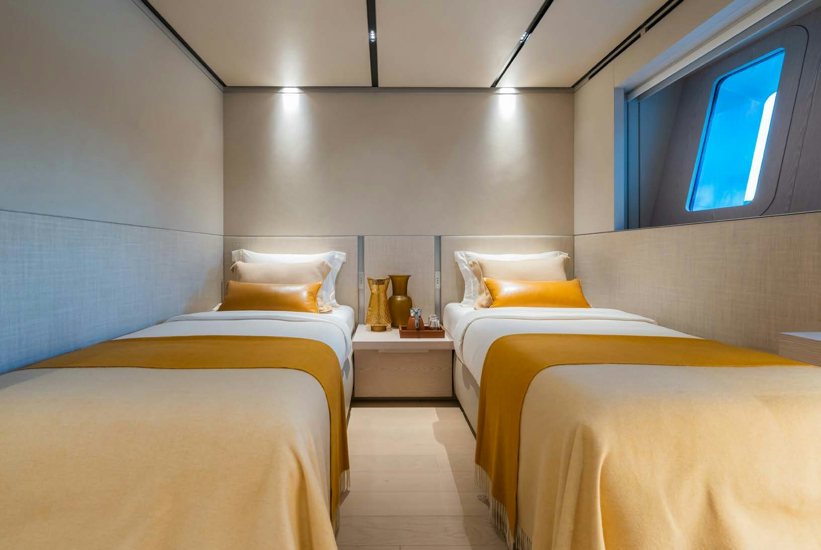 a room with a couple of beds aboard R.M.F Yacht for Charter