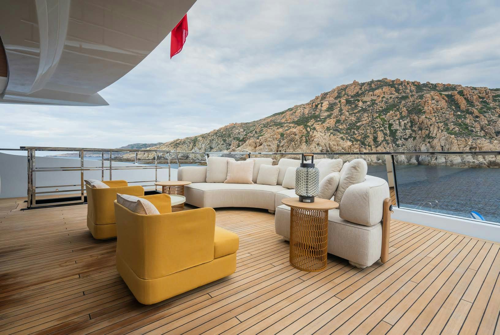 a deck with a couch and a table on it aboard R.M.F Yacht for Charter