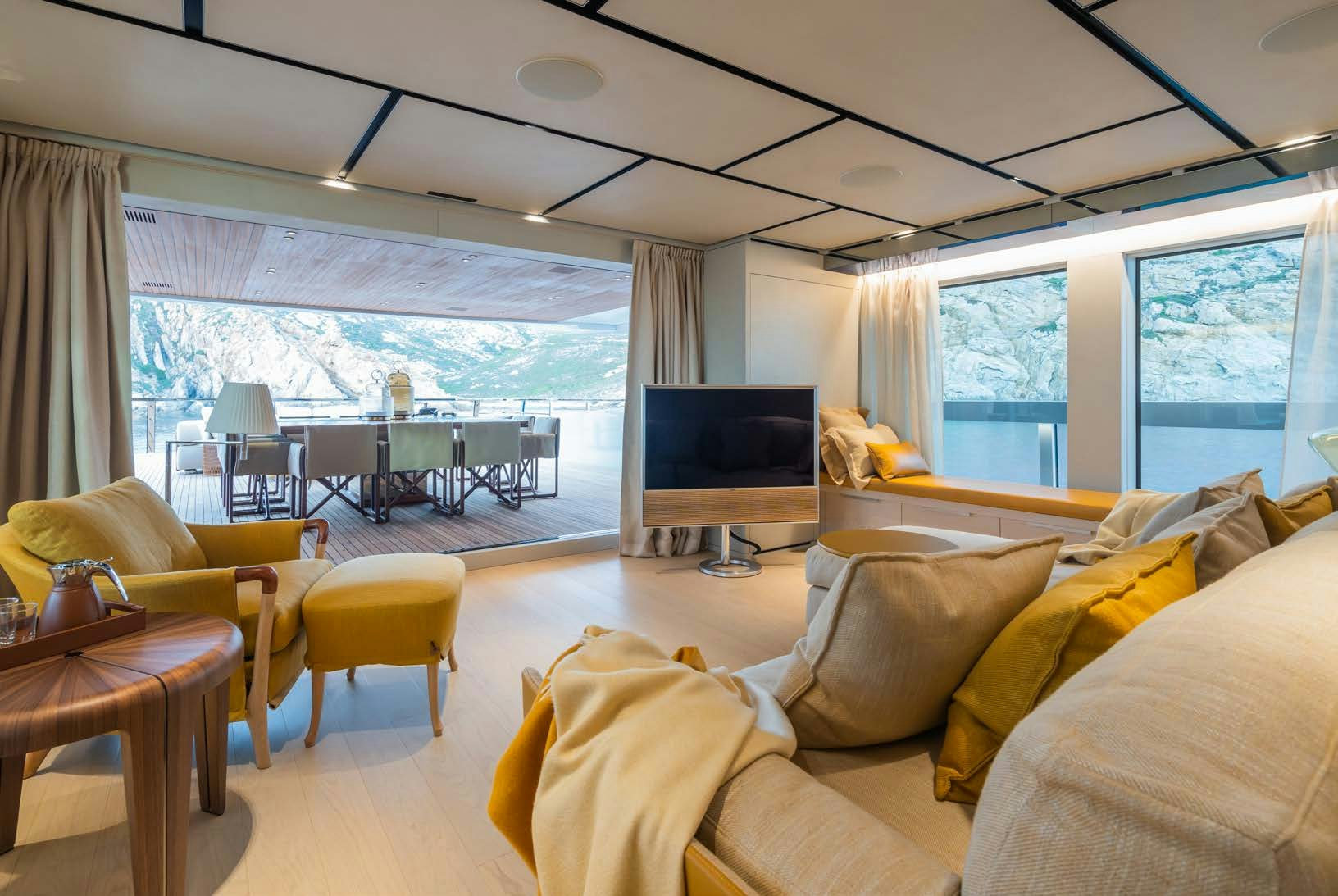 a living room with a large window aboard R.M.F Yacht for Charter