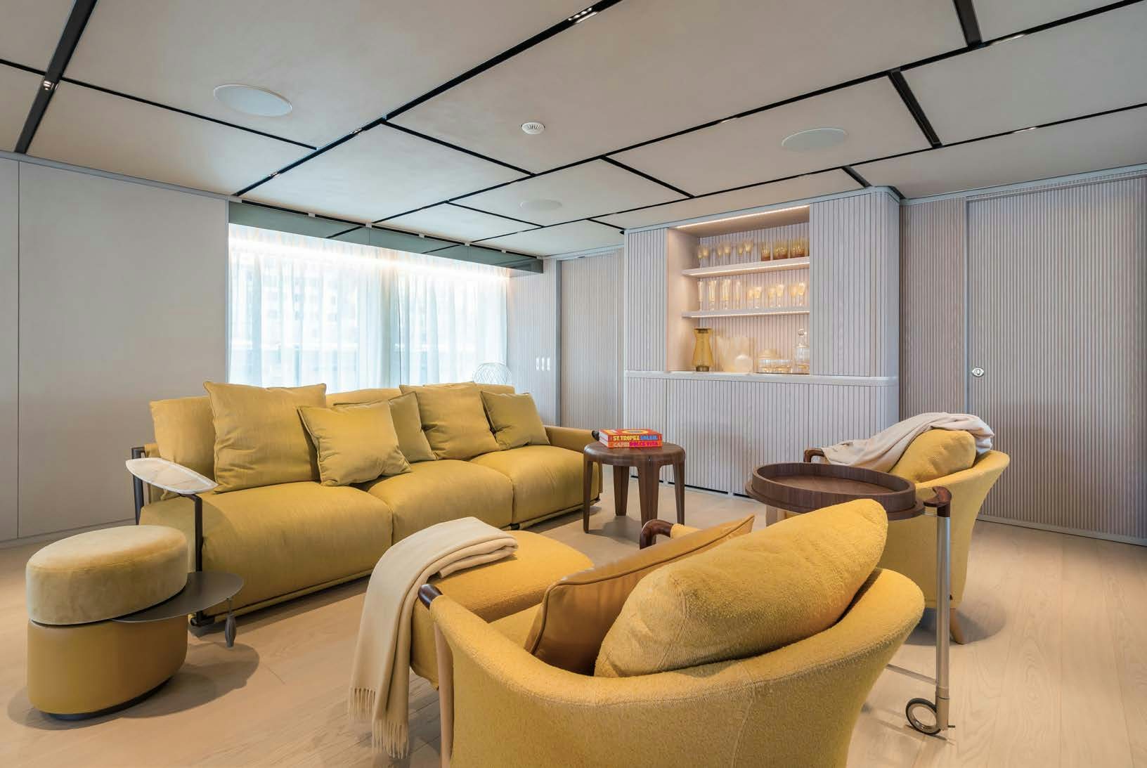 a living room with a couch and a bookcase aboard R.M.F Yacht for Charter