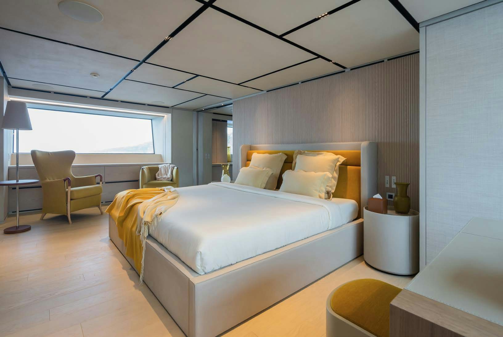 a bedroom with a bed and a desk aboard R.M.F Yacht for Charter