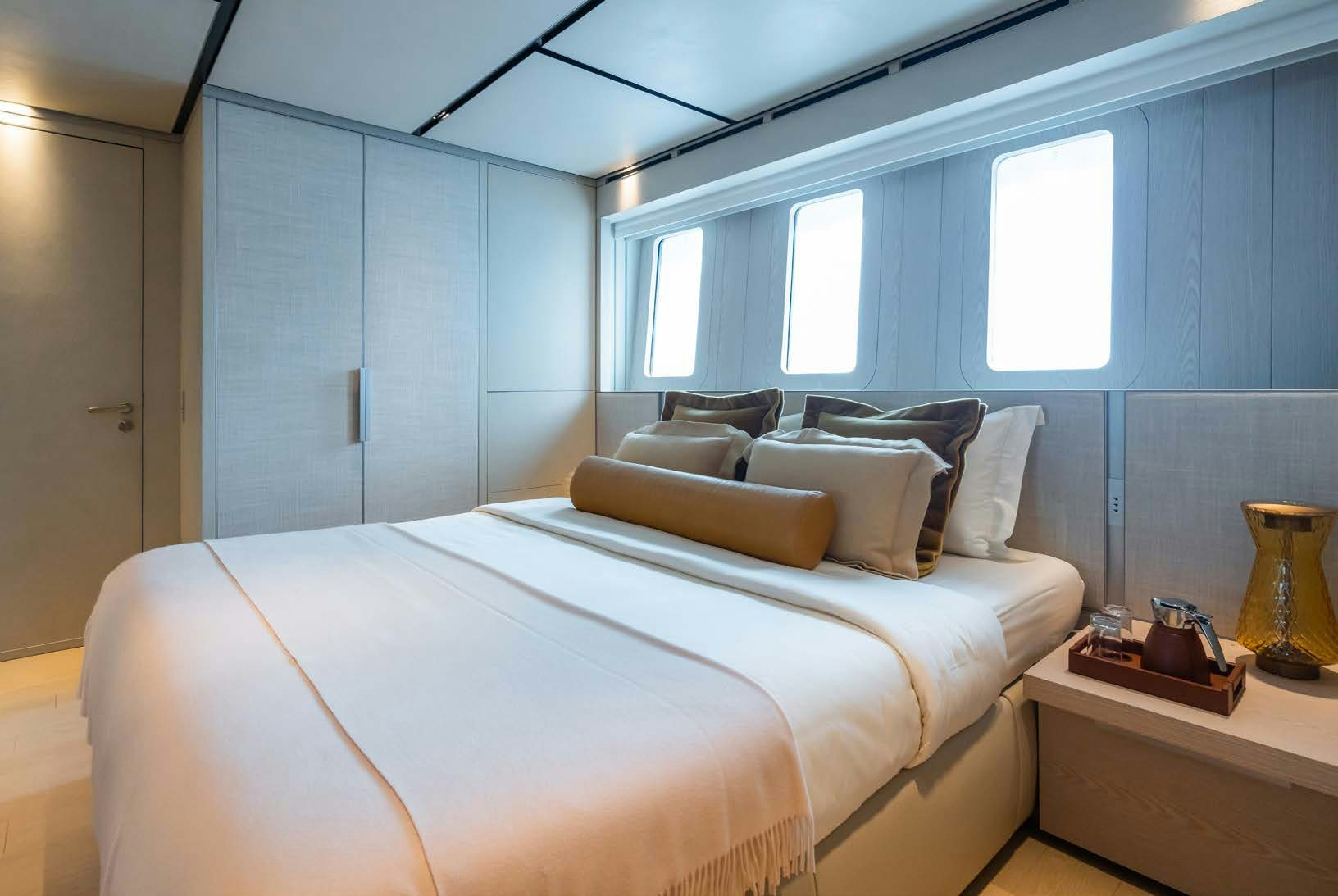 a bed in a room aboard R.M.F Yacht for Charter