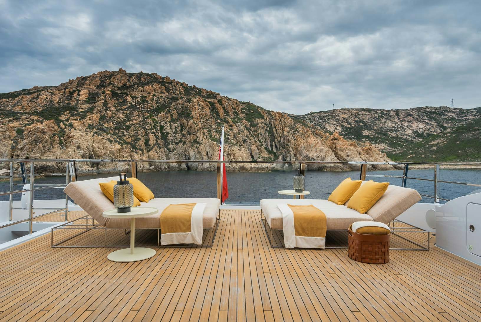 a deck with a table and chairs on it aboard R.M.F Yacht for Charter