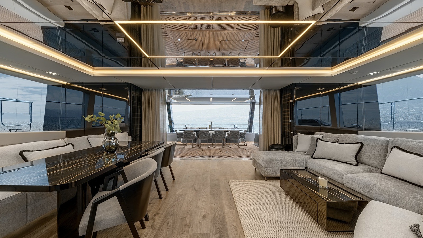 a room with a table and couches aboard AMILEO Yacht for Charter