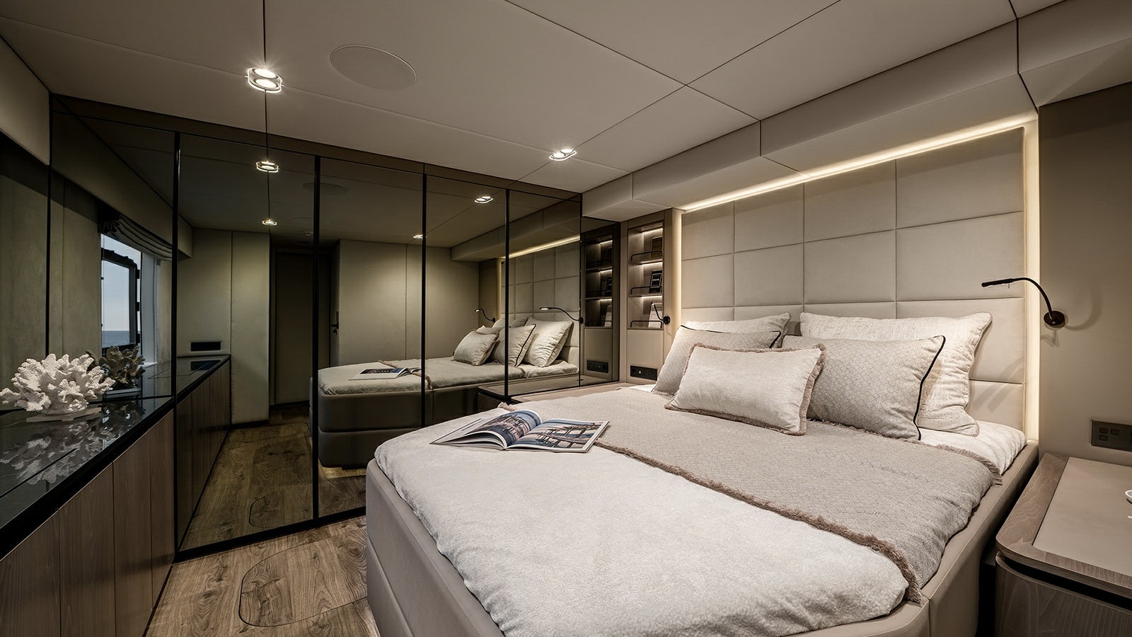 a modern bedroom with a large mirror aboard AMILEO Yacht for Charter